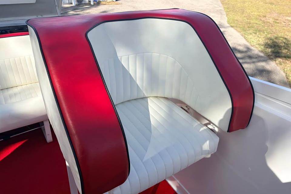 Red and white seating on 1983 Cigarette 24' Classic boat, showcasing vintage design.