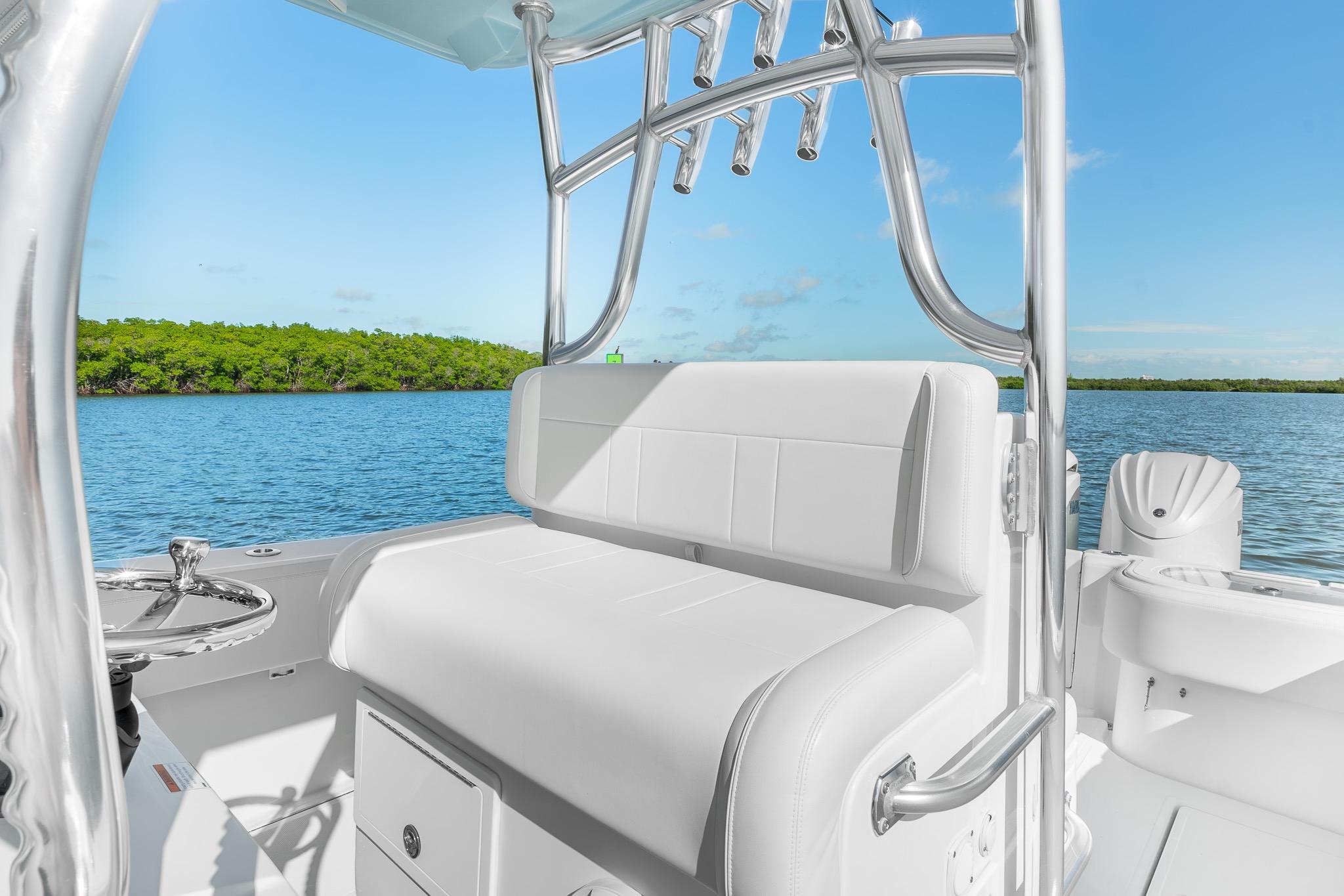2025 SeaHunter 31 Tournament boat interior with white seating, chrome details, and scenic water view.