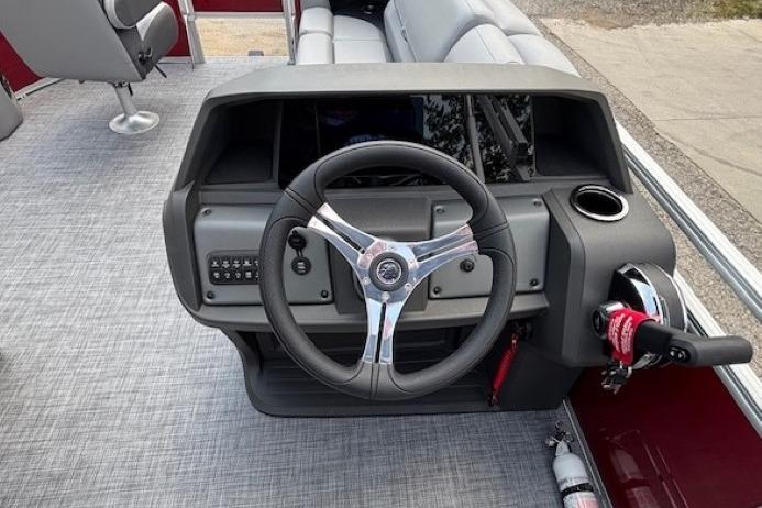 2026 Sun Tracker SportFish 20 DLX boat dashboard with steering wheel and controls.