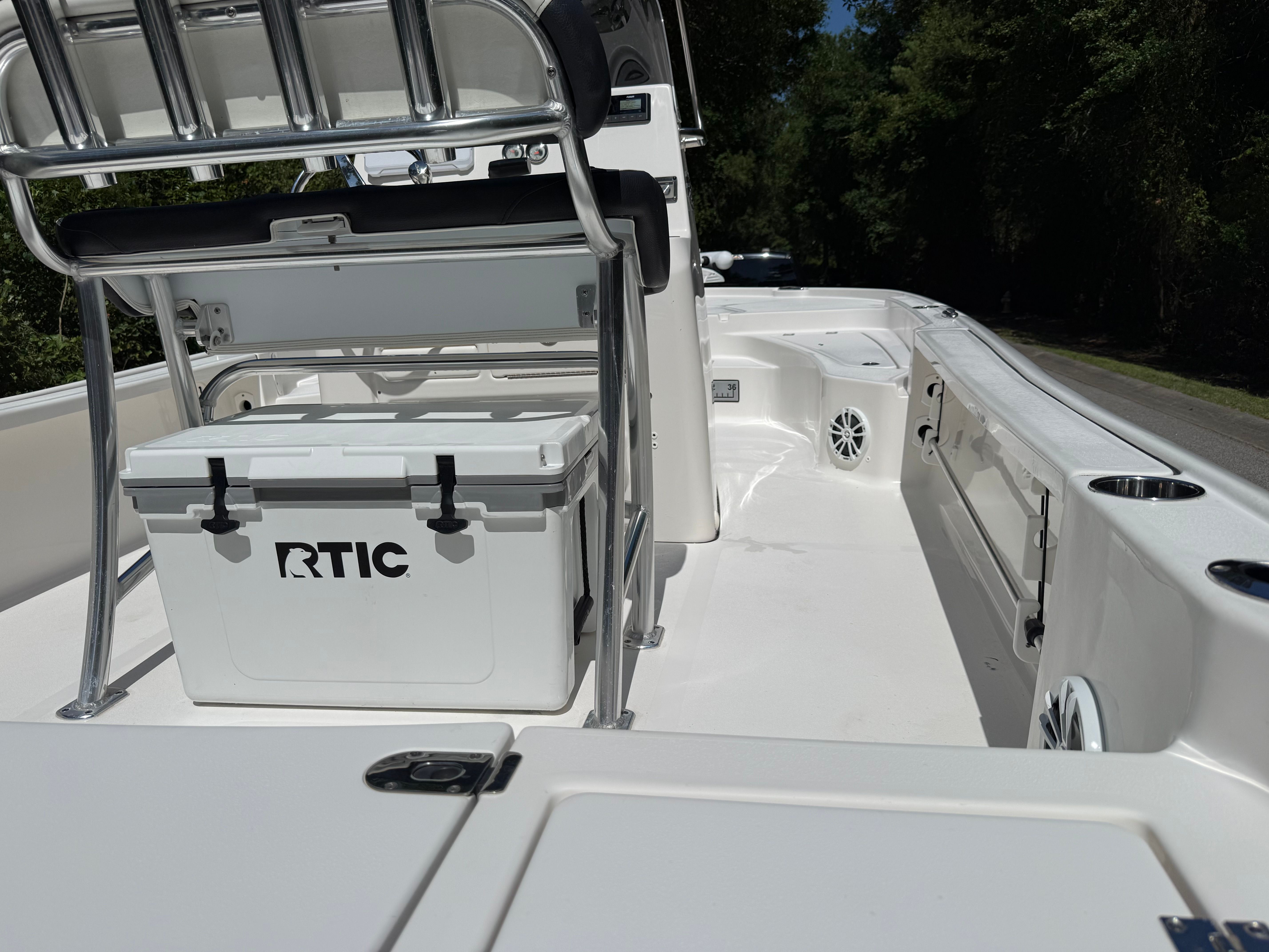 The image shows the deck of a Tidewater 2210 Carolina Bay boat with an RTIC cooler.