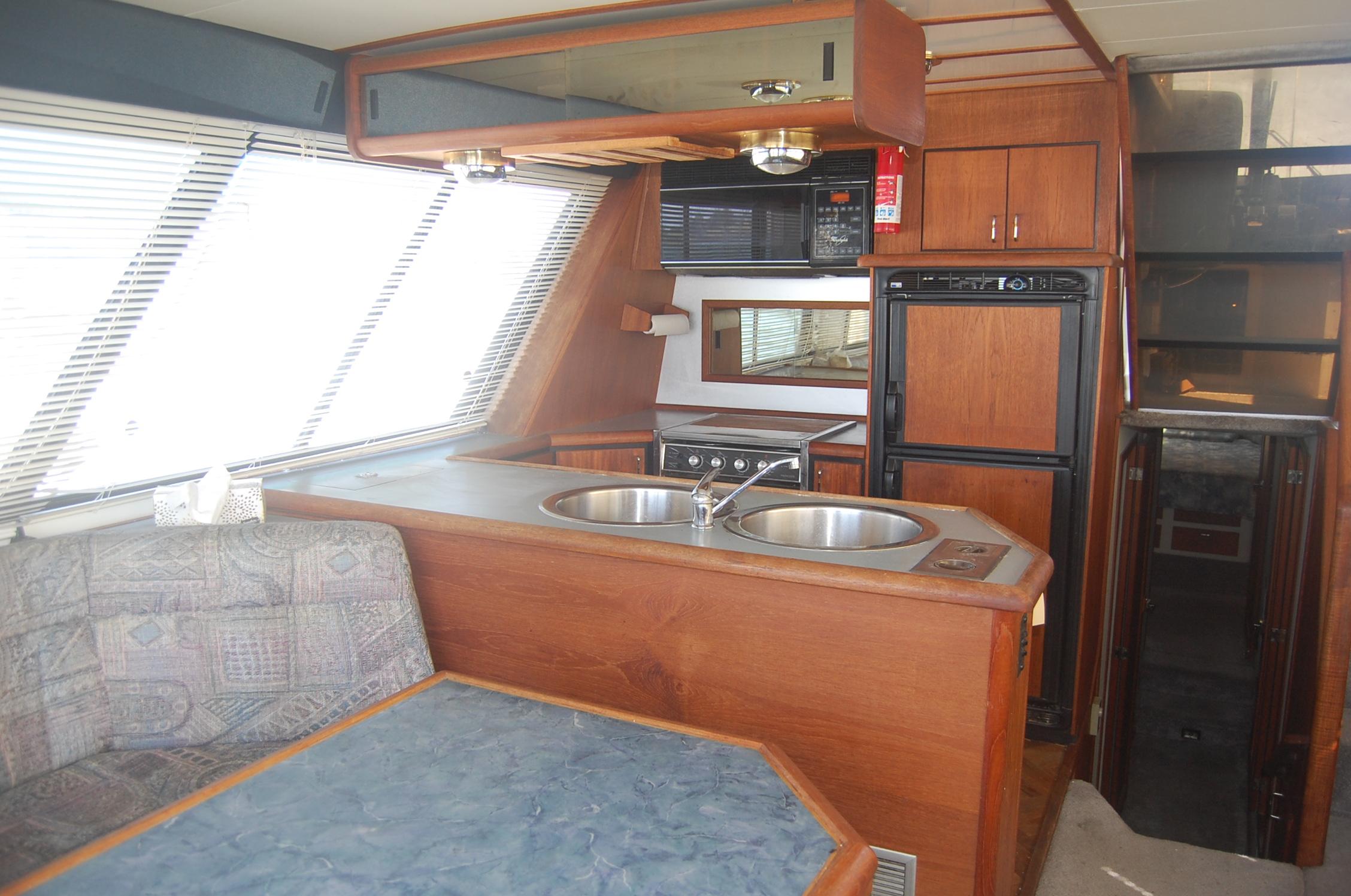 Interior of 1992 Bayliner 4588 Pilothouse MY with kitchen and seating area.