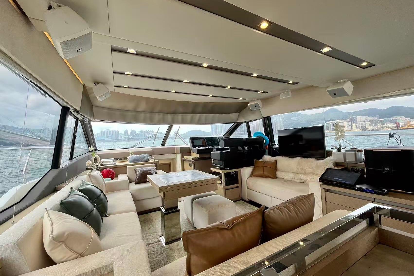Luxurious interior of a 2019 Prestige 630 yacht with modern furnishings and panoramic windows.