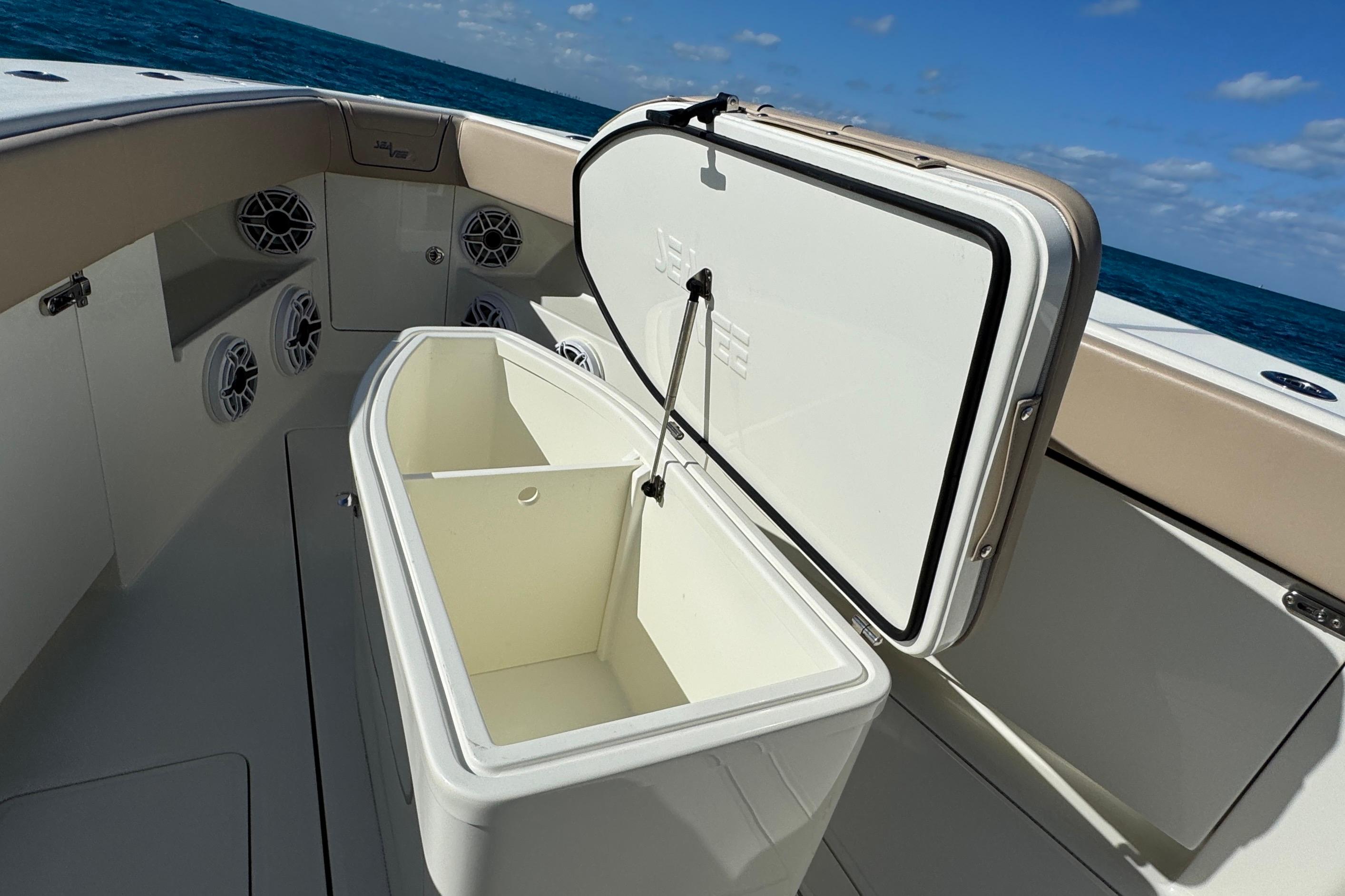 Open storage compartment on 2021 SeaVee Boats 370Z, with ocean view in background.