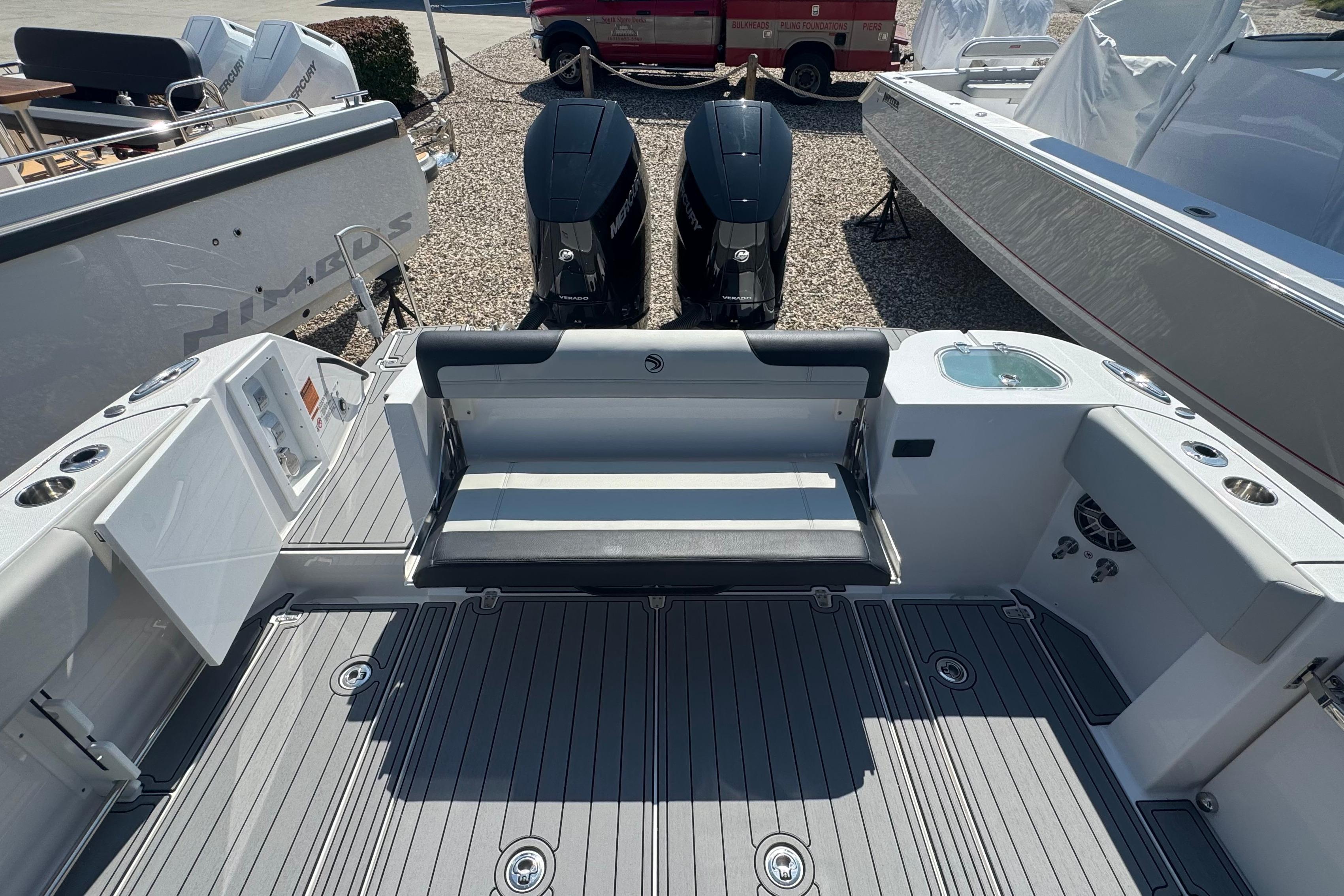 2025 Edgewater 340CC boat interior with seating and dual outboard motors.