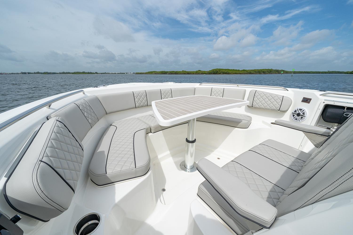 Manufacturer Provided Image: 2025 Pursuit S 358 Sport boat interior with luxurious seating and table on open water.