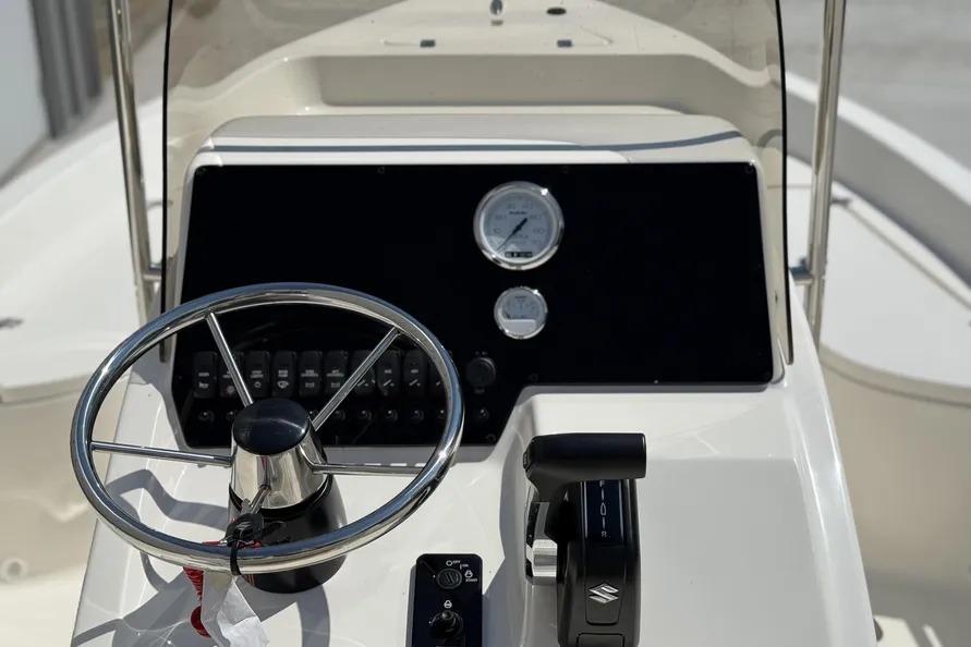 Steering console of 2026 Bulls Bay 2000 boat with gauges and controls.