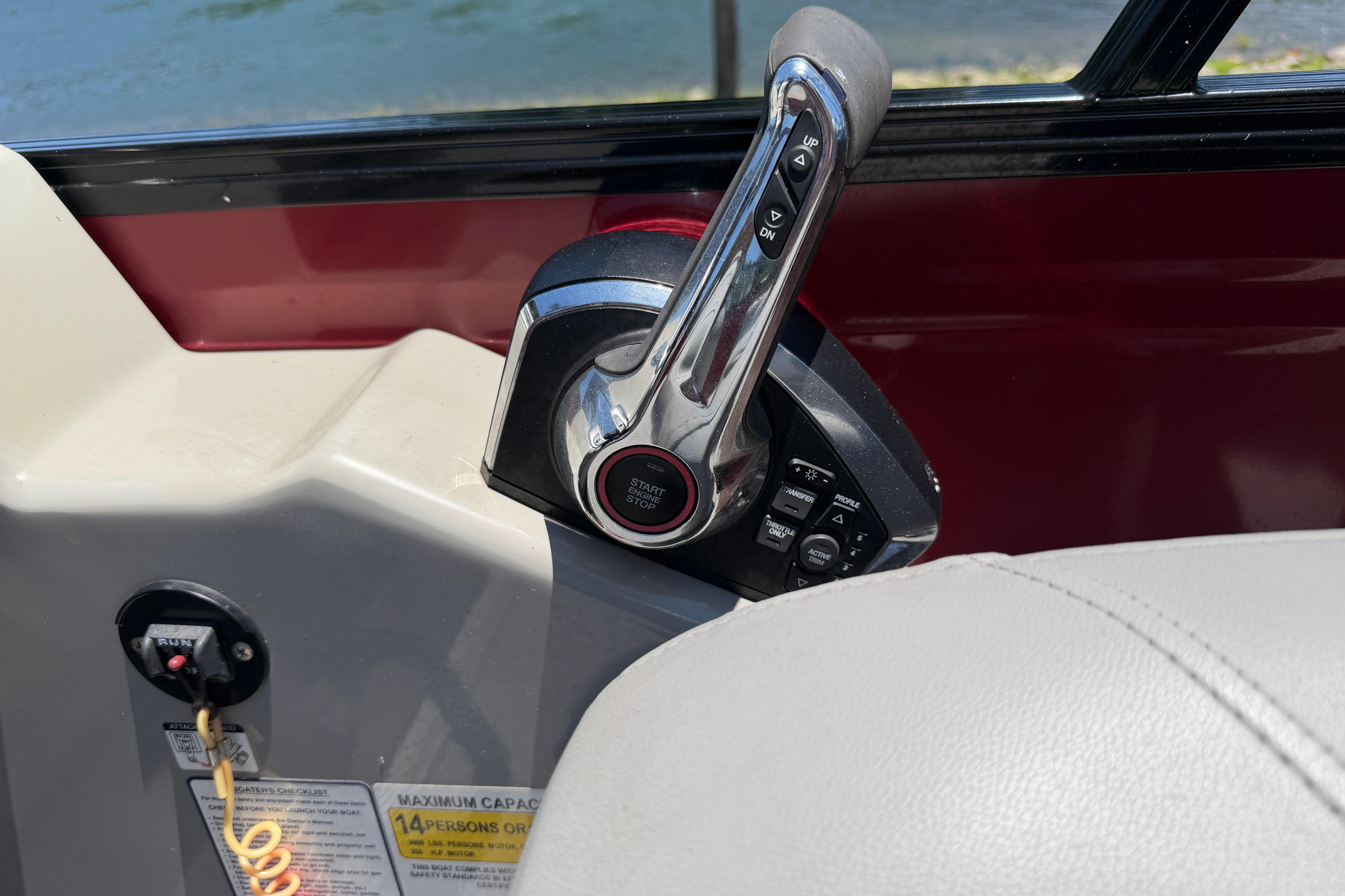 Throttle control of 2024 Regency R250DL3 boat, featuring start/stop button and control panel.