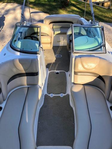 Interior of a 2012 Godfrey Hurricane boat with beige seating.
