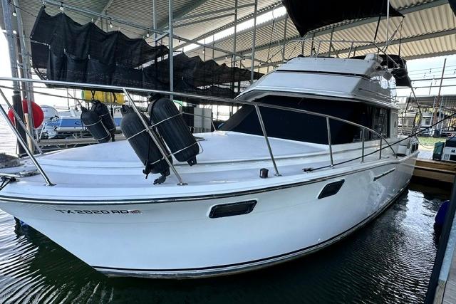 1989 Carver 32 Aft Cabin Motor Yacht docked in marina.