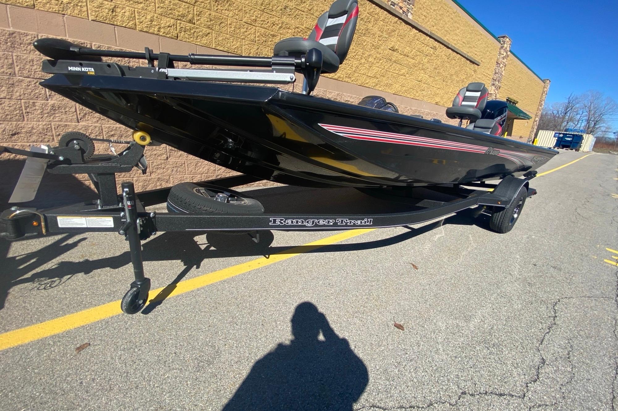 2026 Ranger RT188 boat on trailer, parked outdoors, featuring sleek black design.
