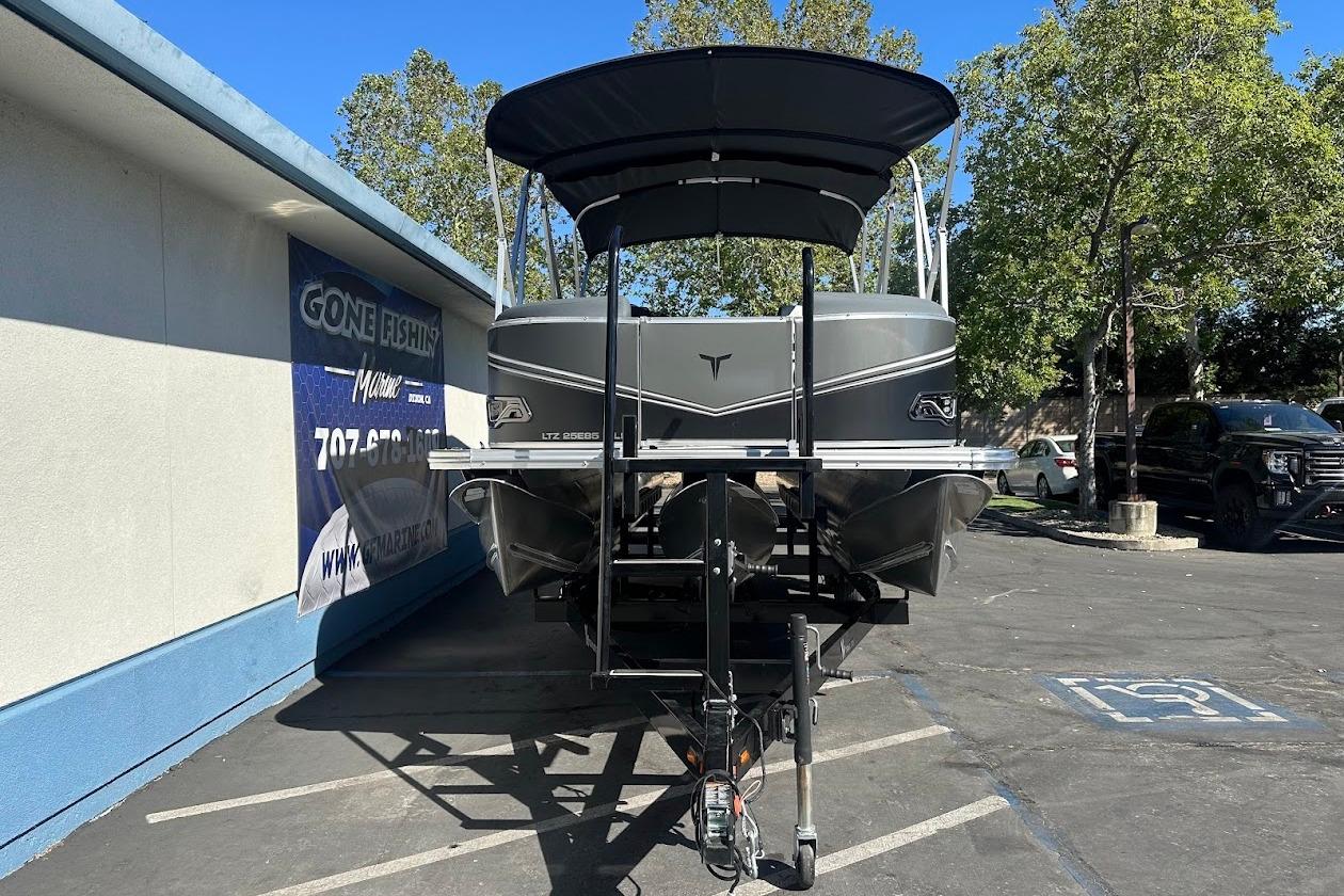 2026 Tahoe Pontoon LTZ Quad Lounger Shift 23 on trailer, parked outdoors.