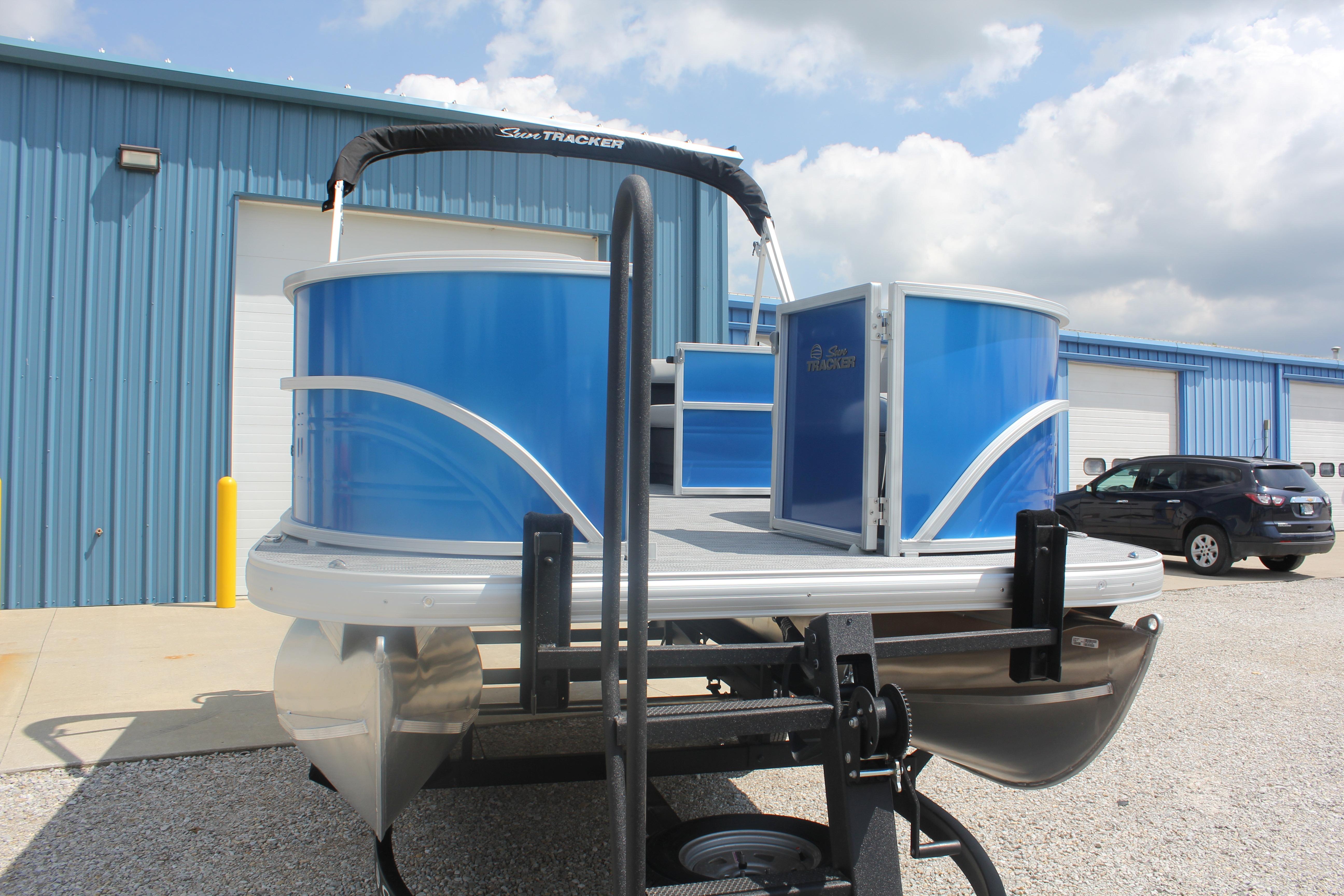 2026 Sun Tracker Party Barge 16 DLX pontoon boat in a parking lot.