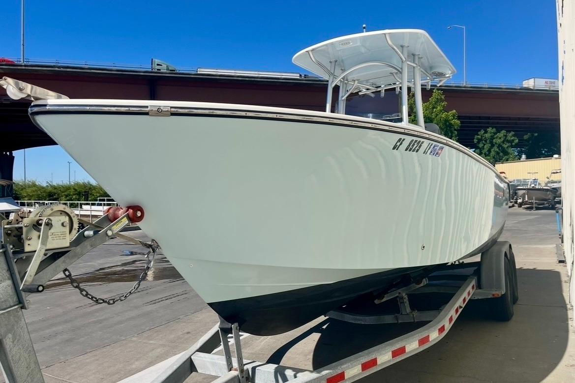 2025 Defiance Catalina 240 boat on trailer under clear blue sky.