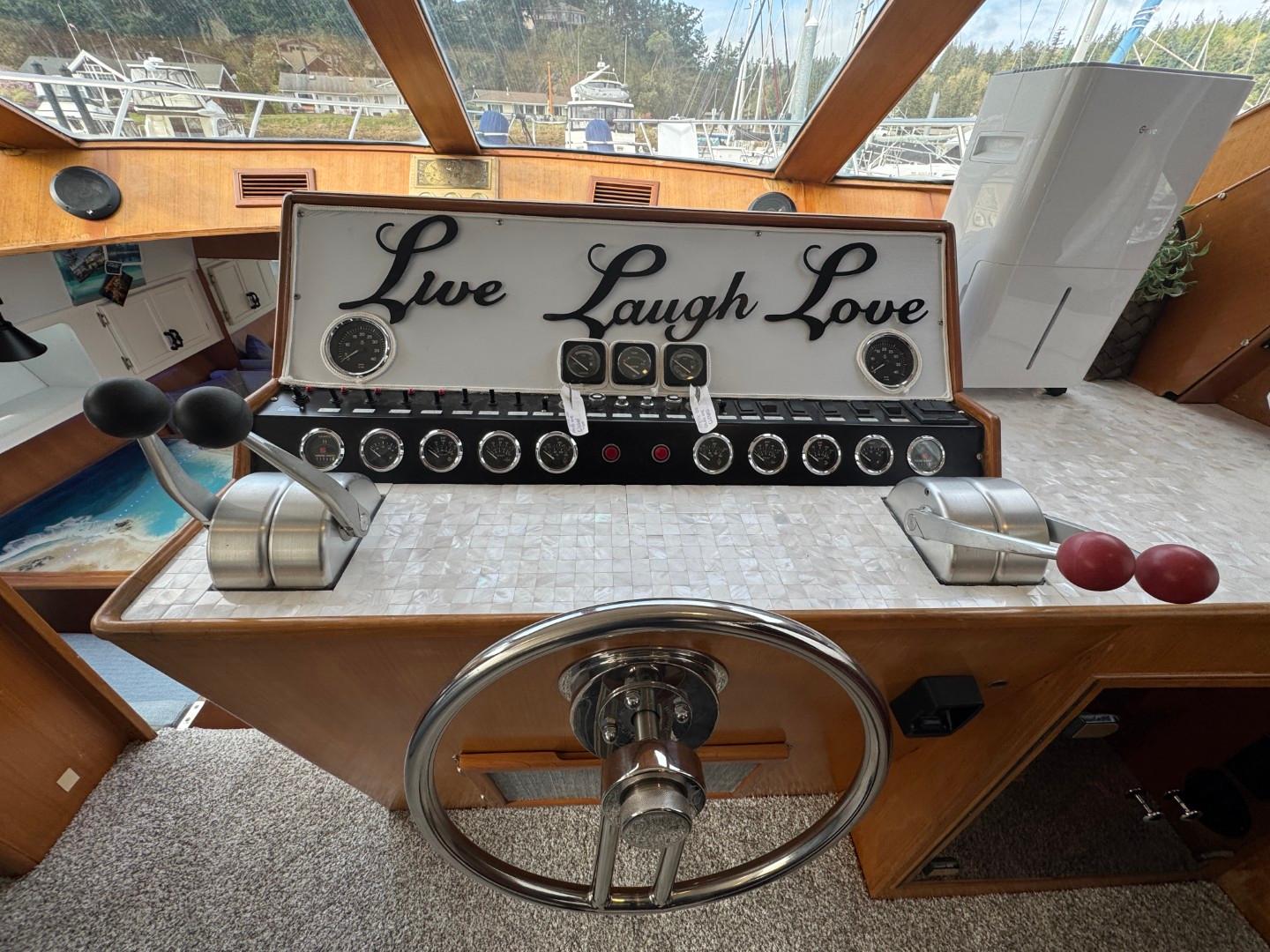Cockpit of 1989 Prima 52 Motor Yacht with "Live Laugh Love" sign.