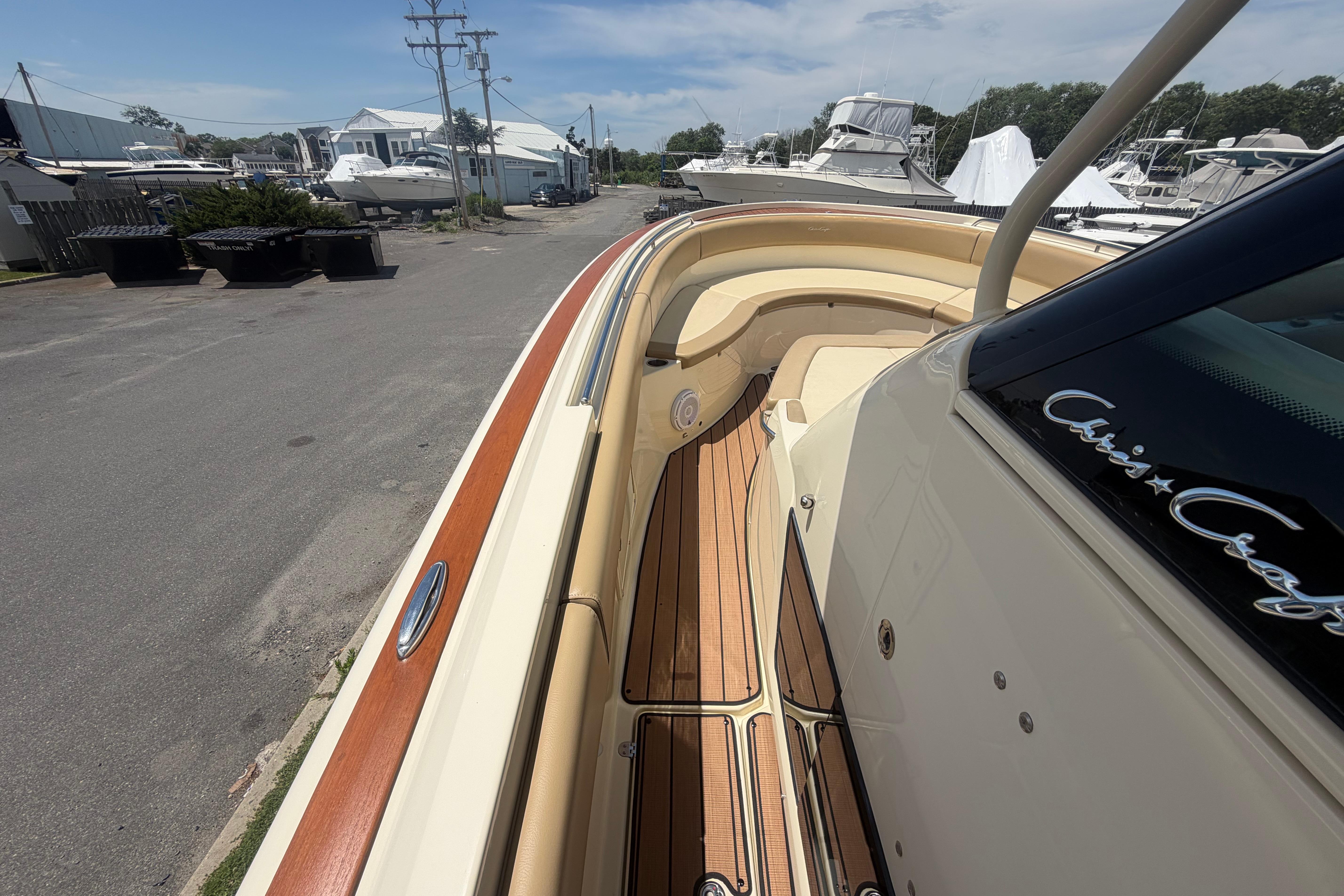 2017 Chris-Craft Catalina 34 boat with teak deck and elegant design in a marina setting.