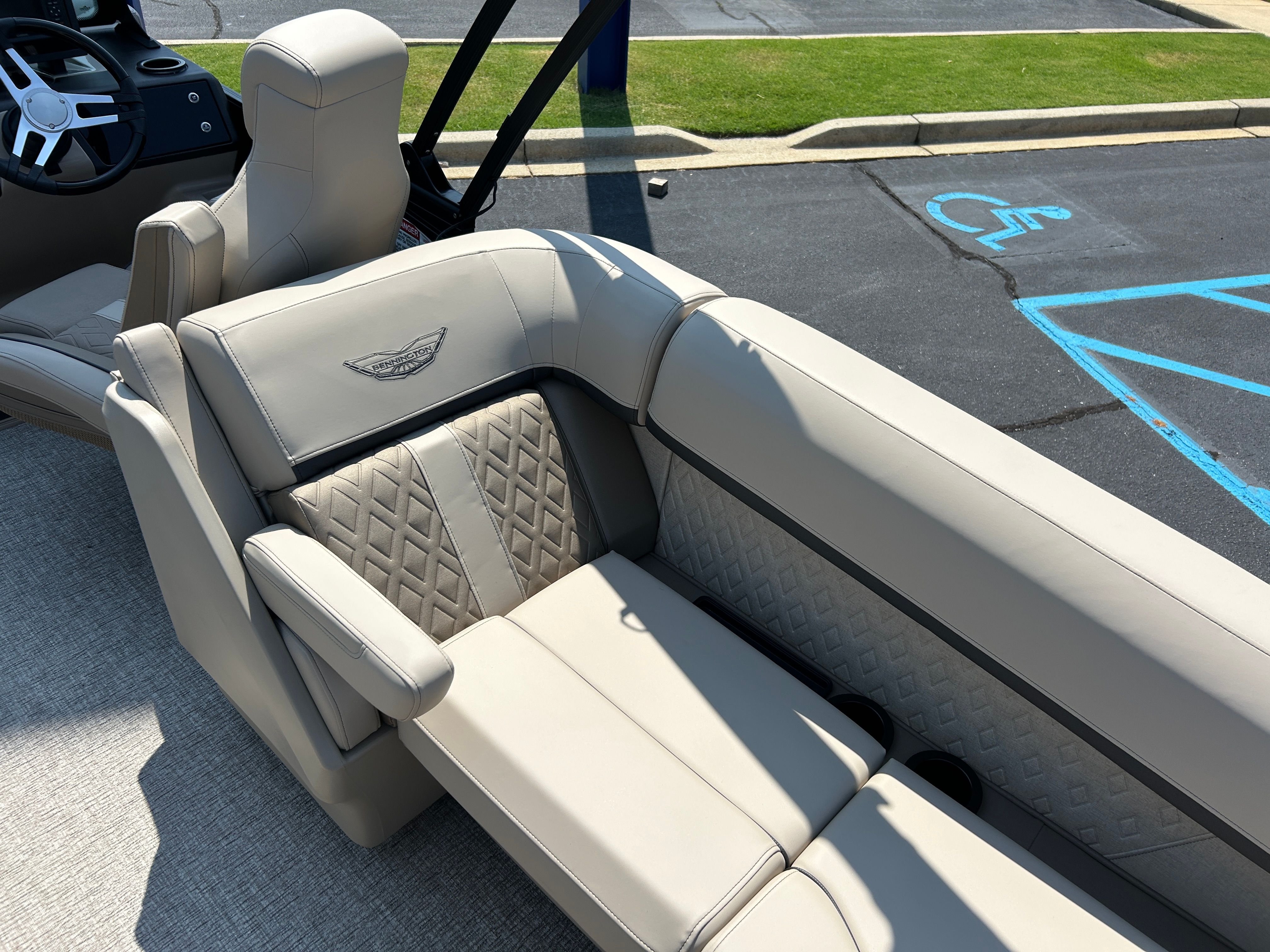 Luxurious beige upholstery on a Bennington 22 MFB boat, parked in a parking lot.