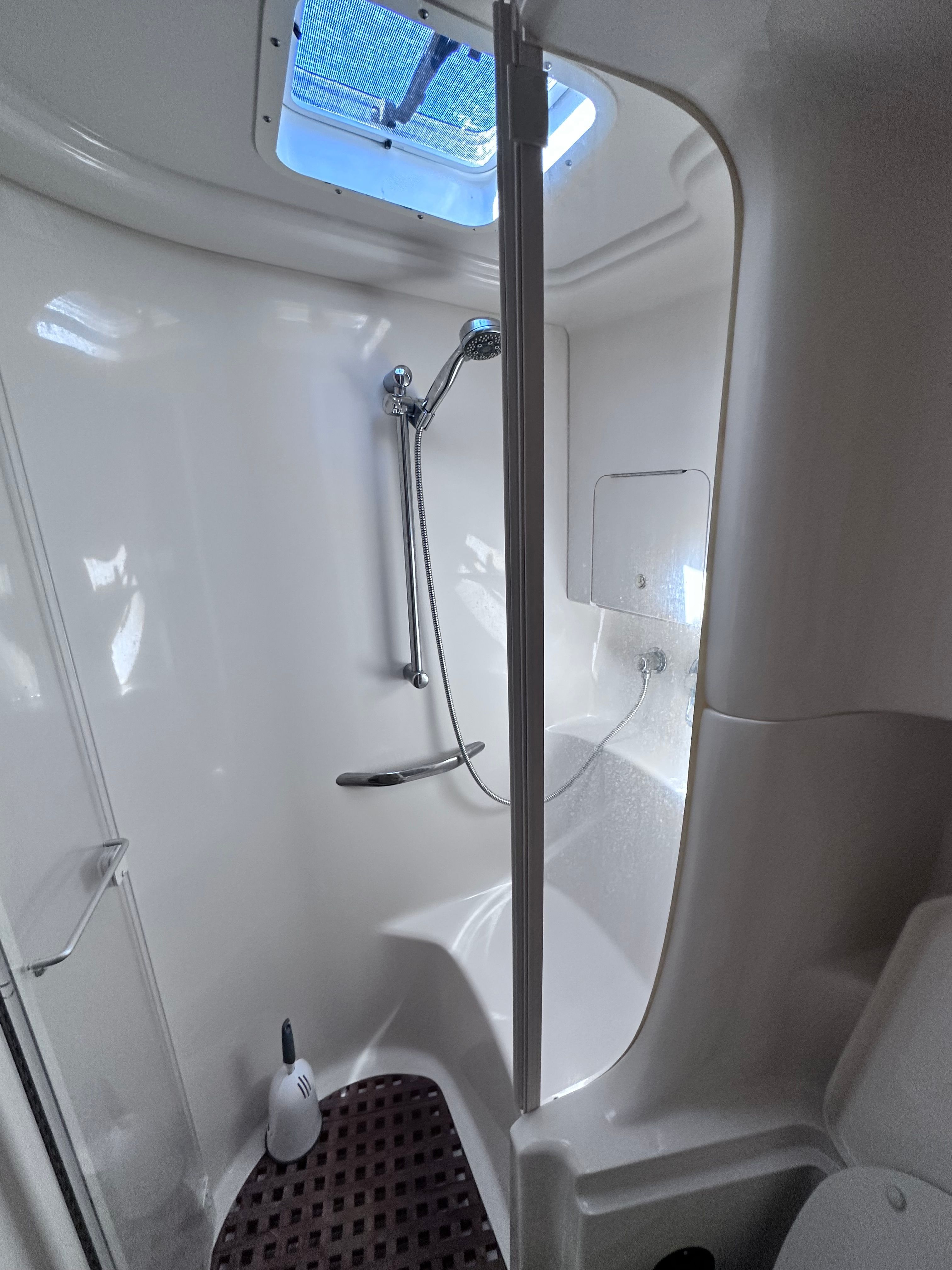 Bathroom interior of 2000 Sea Ray 380 Sundancer yacht with shower and skylight.