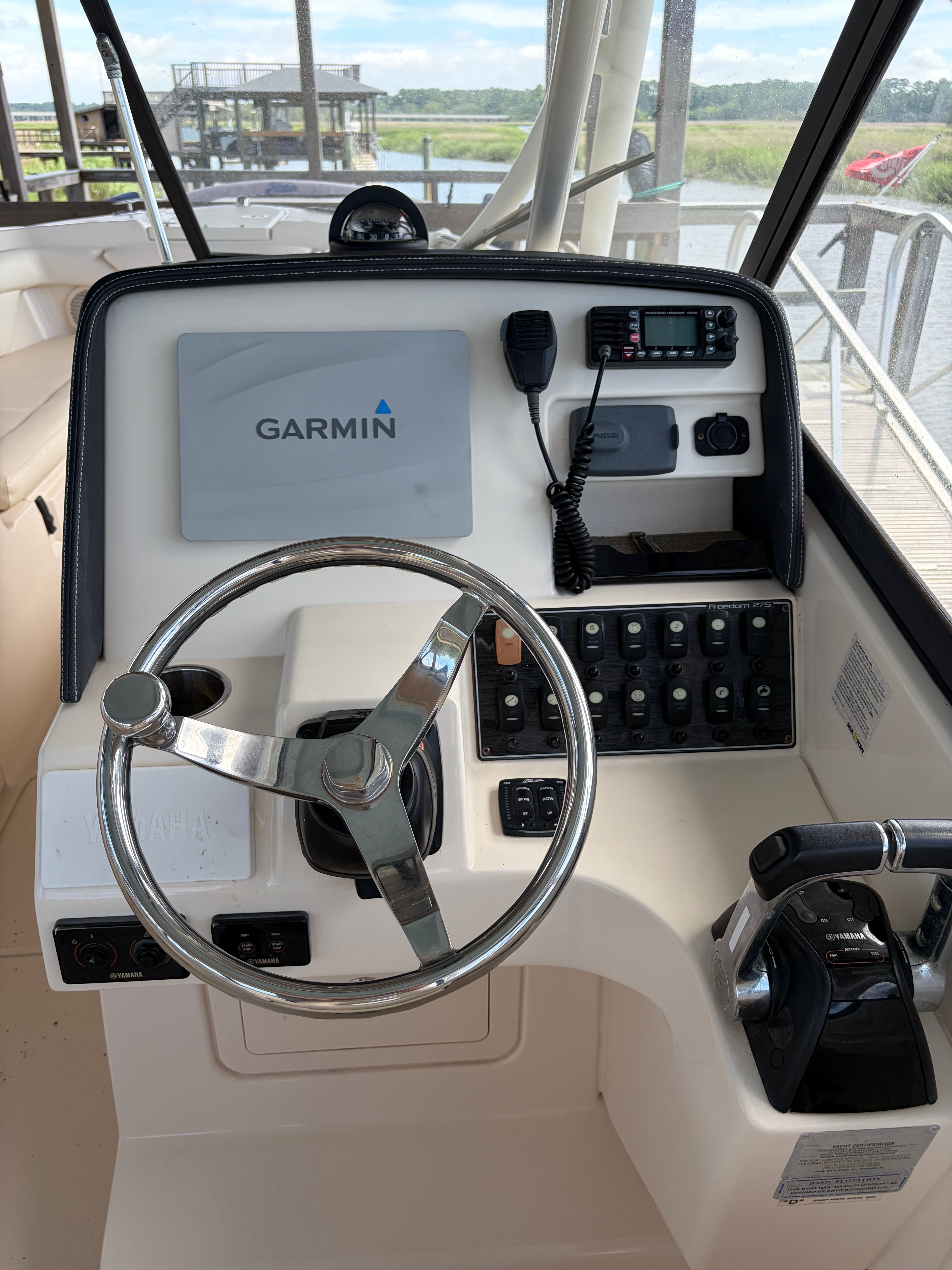 The image shows the helm of a 2016 Grady-White Freedom 275 boat with Garmin navigation.