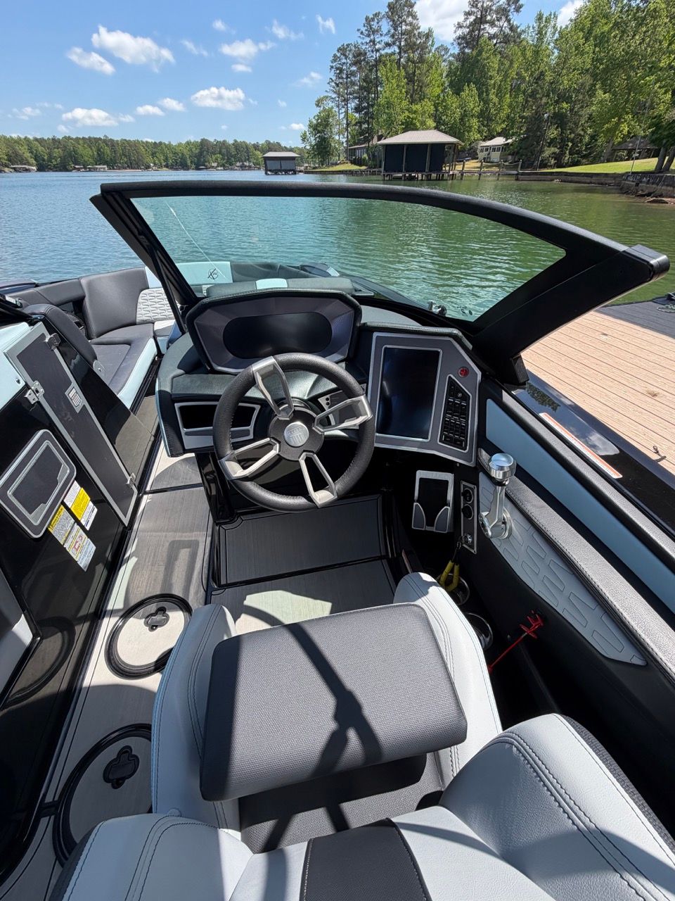 Interior of a 2023 MasterCraft X24 boat by the lake.