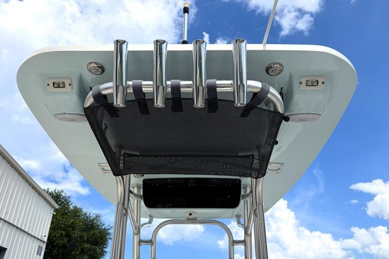 2024 Key West 239 FS boat top view with rod holders against blue sky.