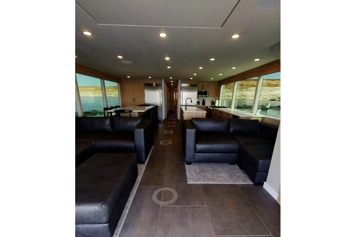 Luxurious interior of Adonia Galileo Trip #1 houseboat, featuring modern kitchen and comfortable seating, 2023.