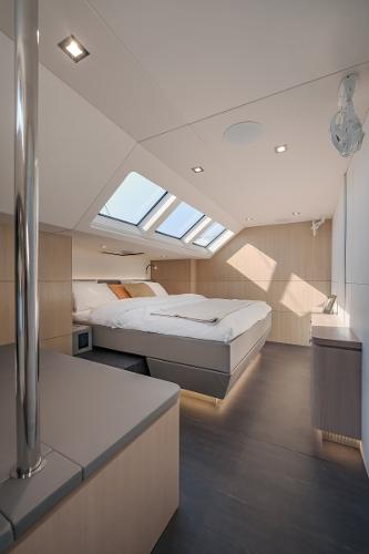 Luxurious 2025 Privilege Signature 650 yacht bedroom with skylights and modern design.