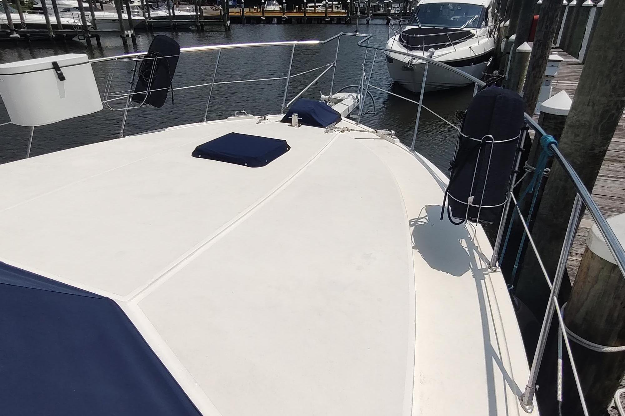 1989 Hyatt Double Cabin Motoryacht docked, showcasing spacious deck and sleek design.