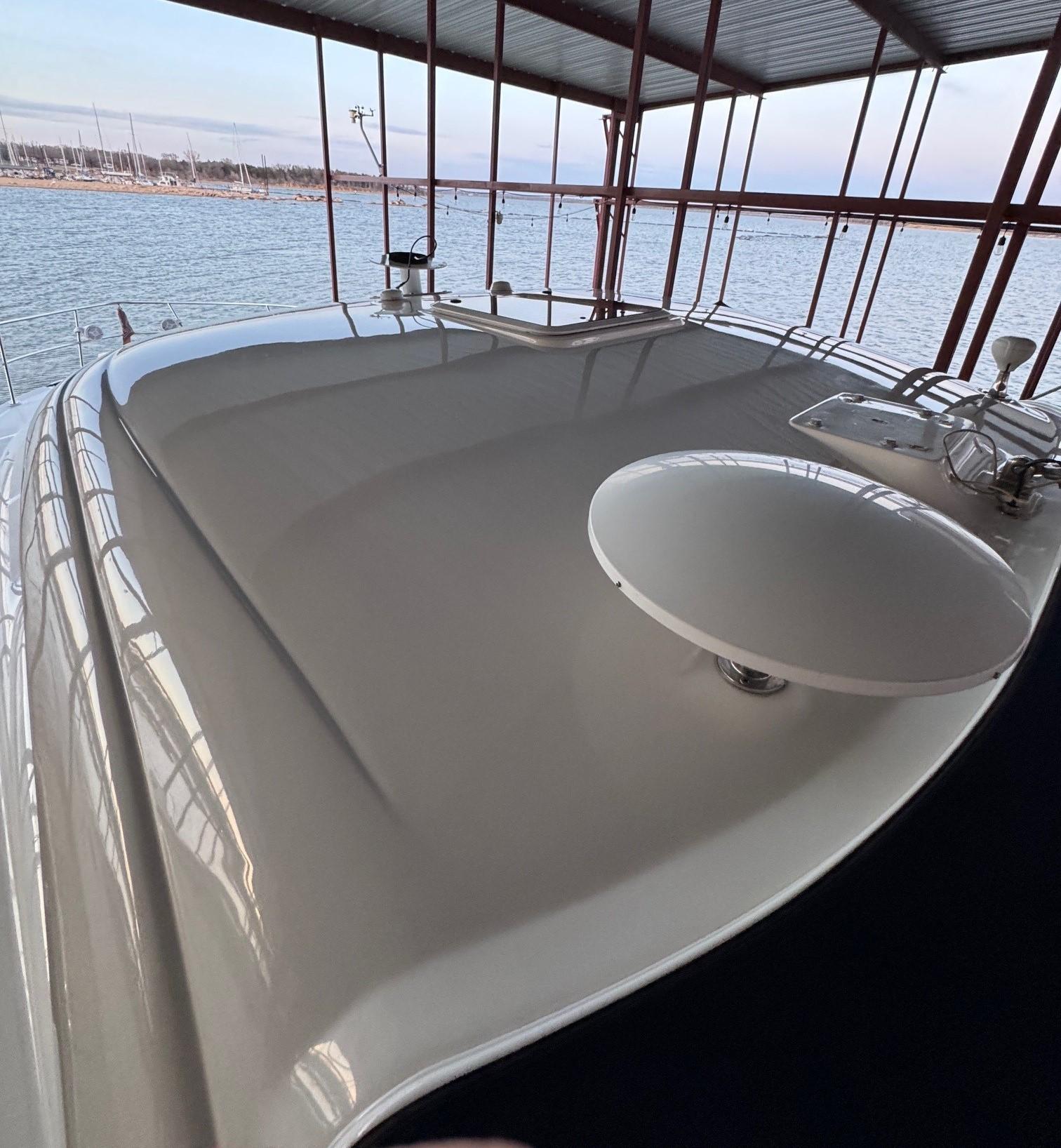 2007 Sea Ray 38 Sundancer yacht docked, showcasing sleek deck design and waterfront view.