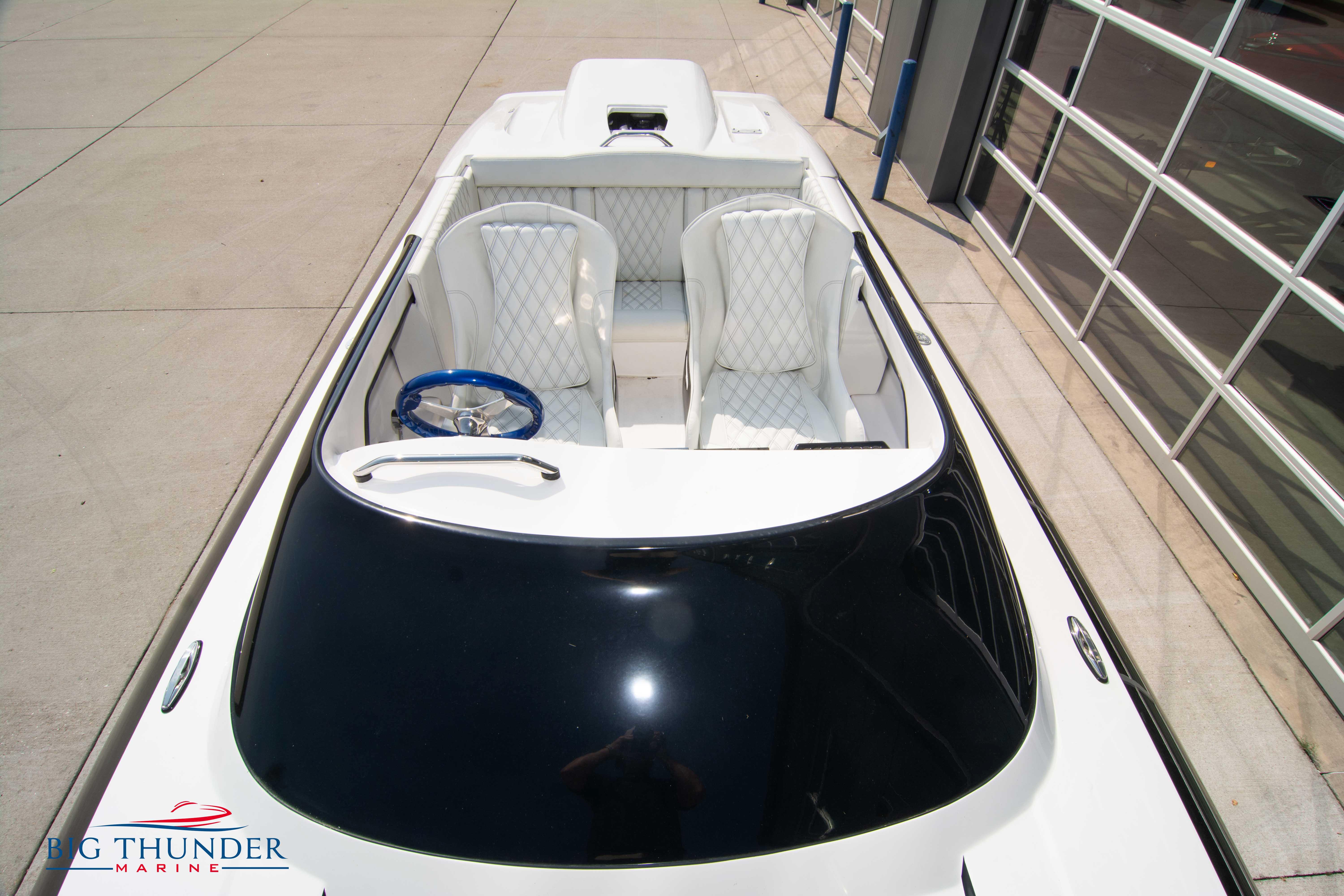 2019 Spectre Screaming Eagle 22 Talon boat with white interior and blue steering wheel.