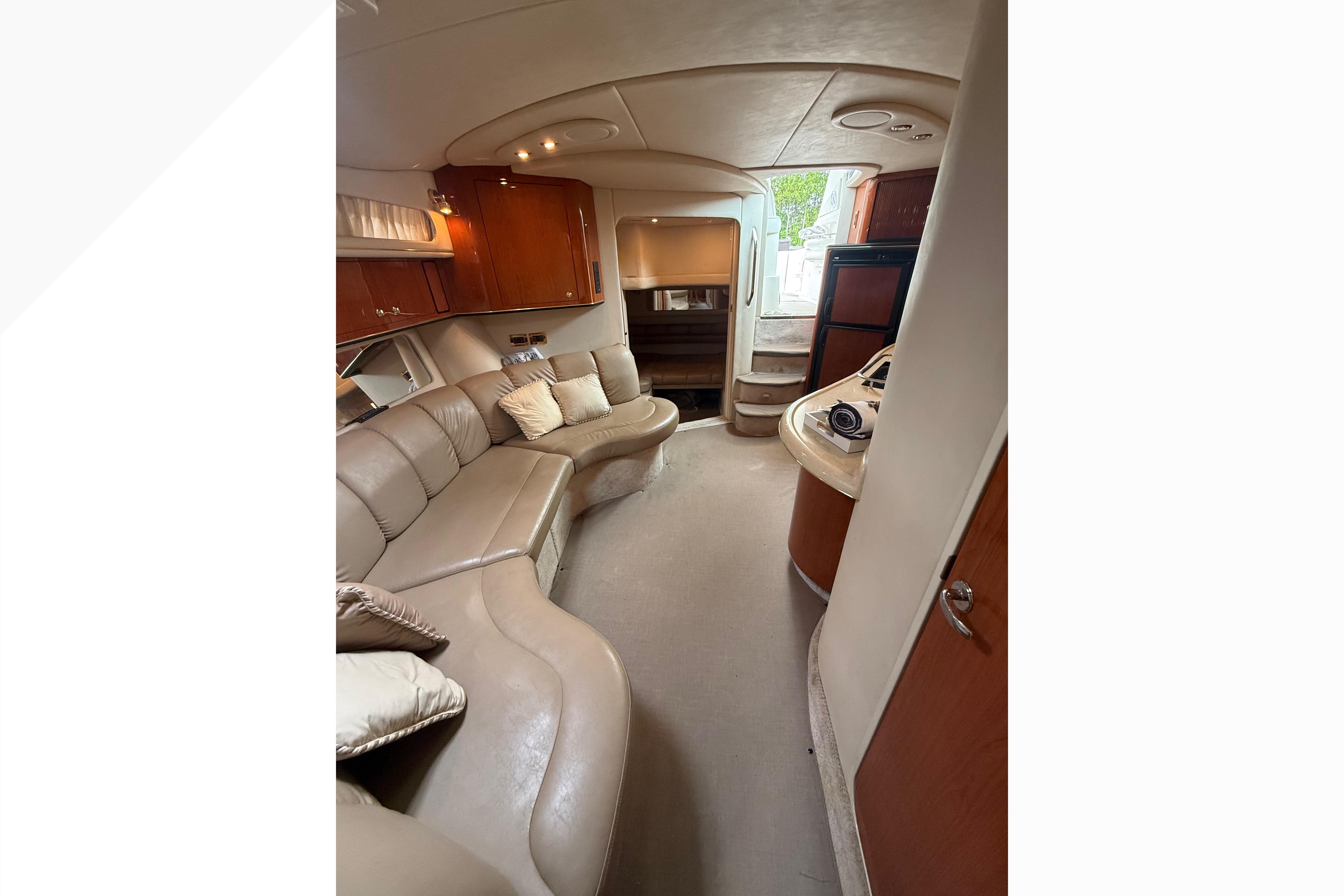 Luxurious interior of a 1998 Sea Ray Sundancer 400 yacht with plush seating and elegant cabinetry.