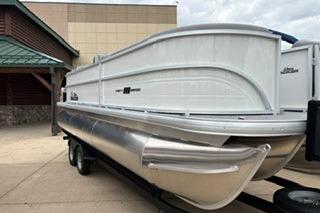 2026 Sun Tracker Party Barge 22 XP3 pontoon boat on trailer, parked outdoors.