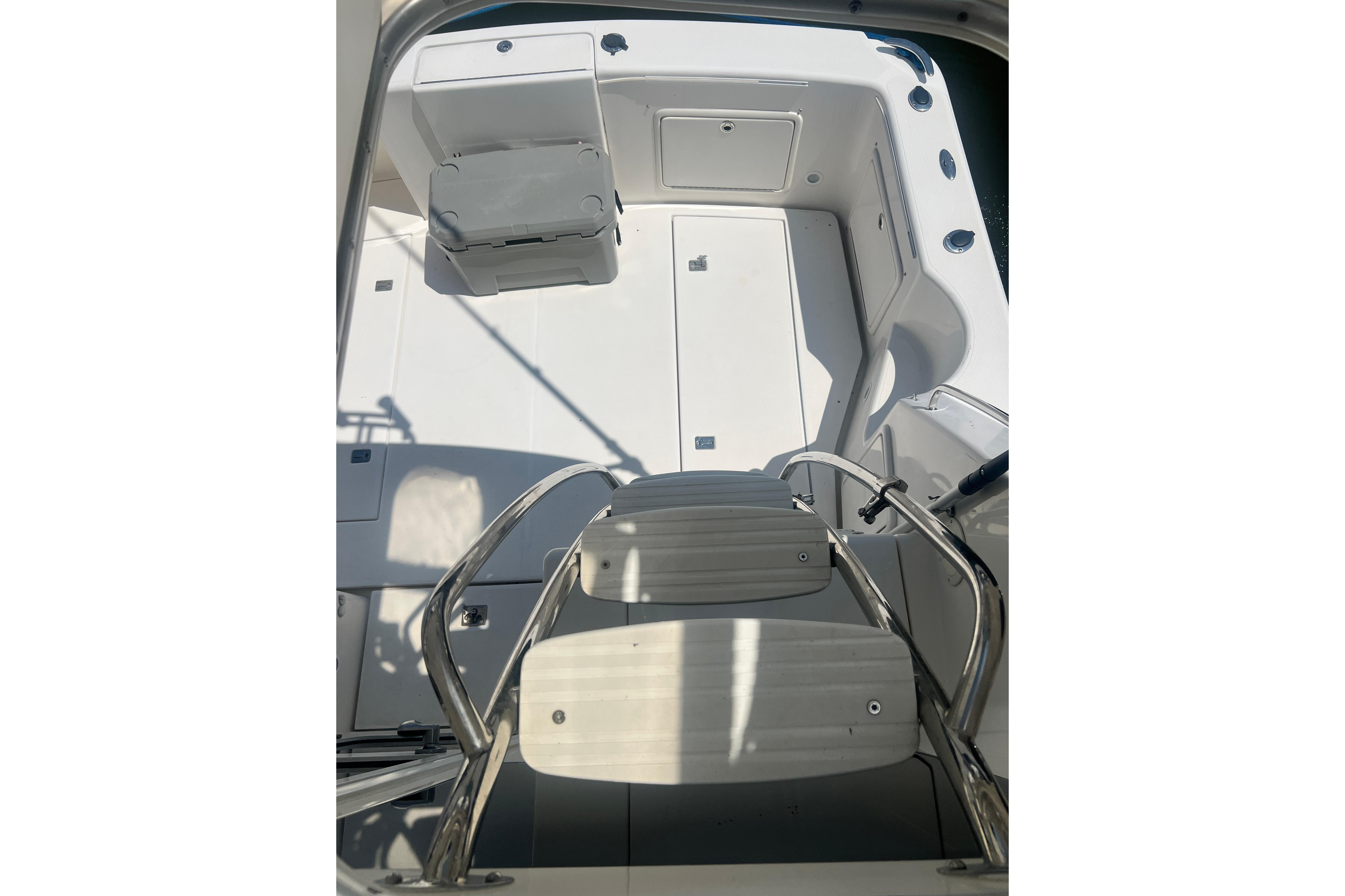 2007 Riviera 33 Flybridge boat deck with seating and stainless steel ladder.