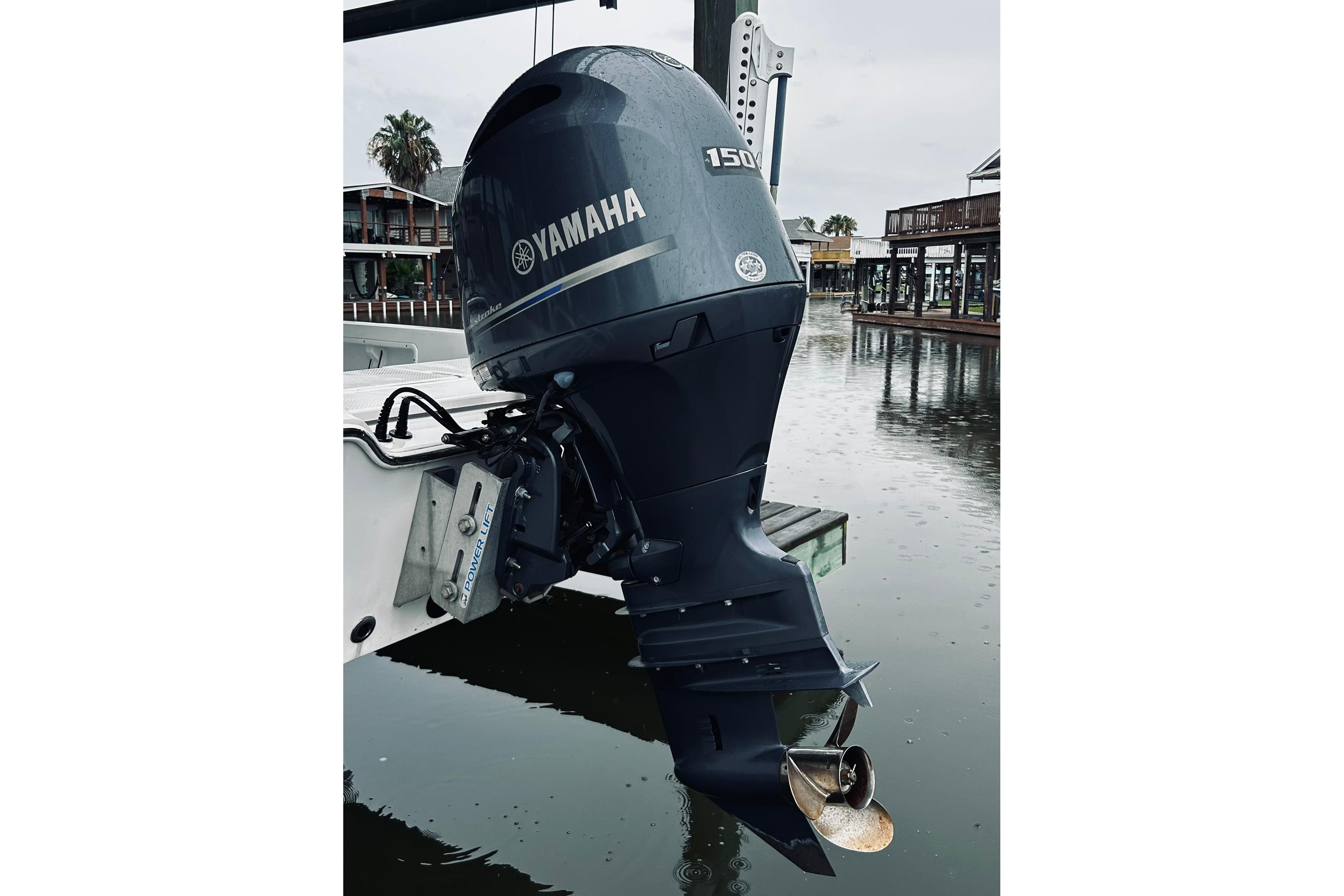 Yamaha 150 outboard motor on 2017 Blue Wave 2200 PureBay boat, docked by waterfront.