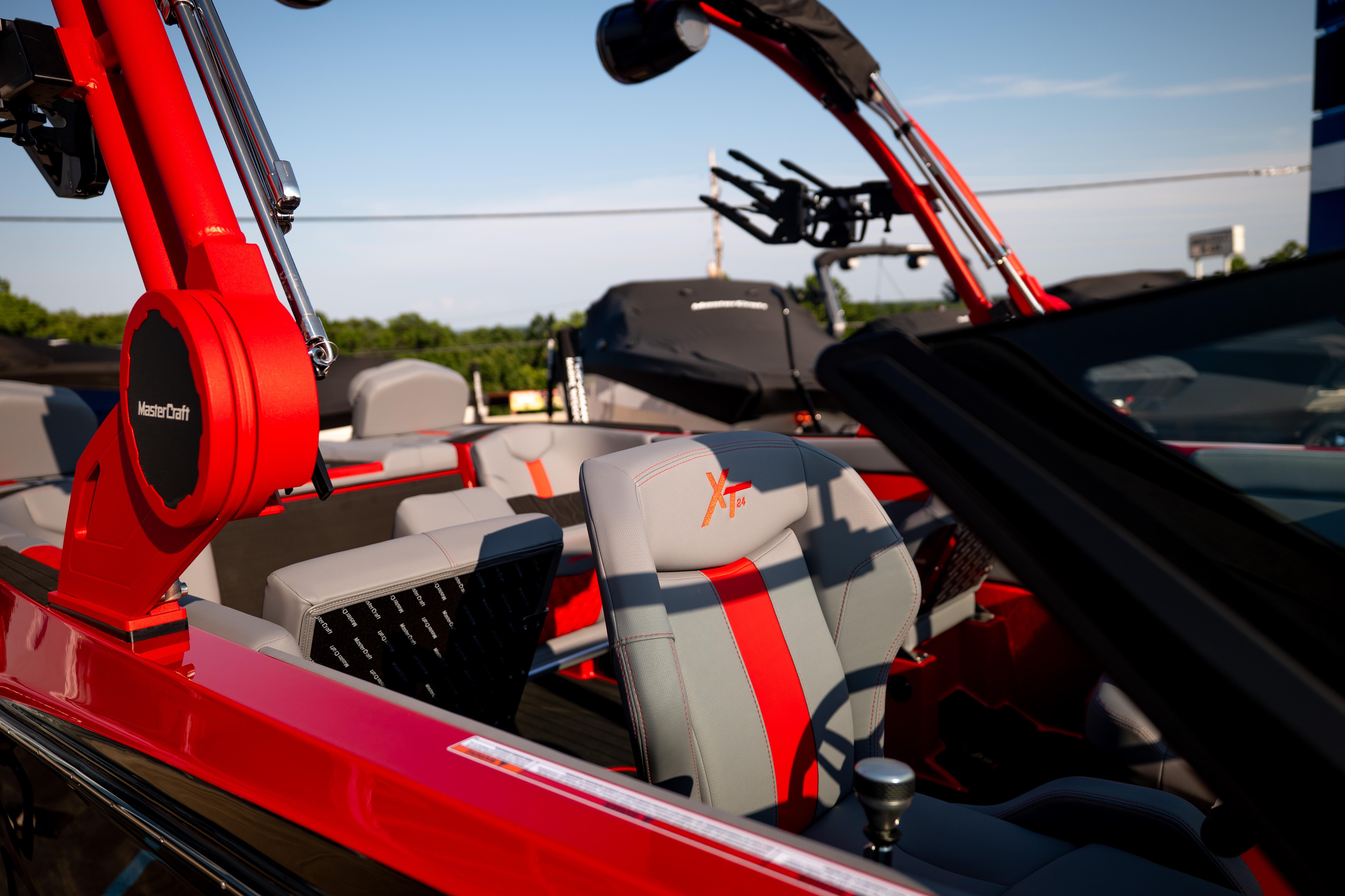 2027 MasterCraft XT24 boat interior with red and gray seating, showcasing modern design.