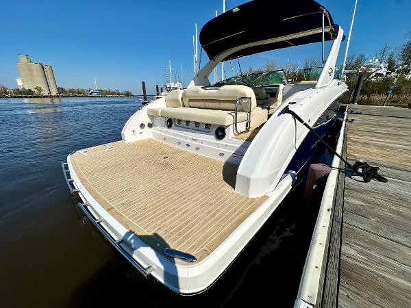 2018 Regal 3300 at dock with spacious deck and beige seating area.