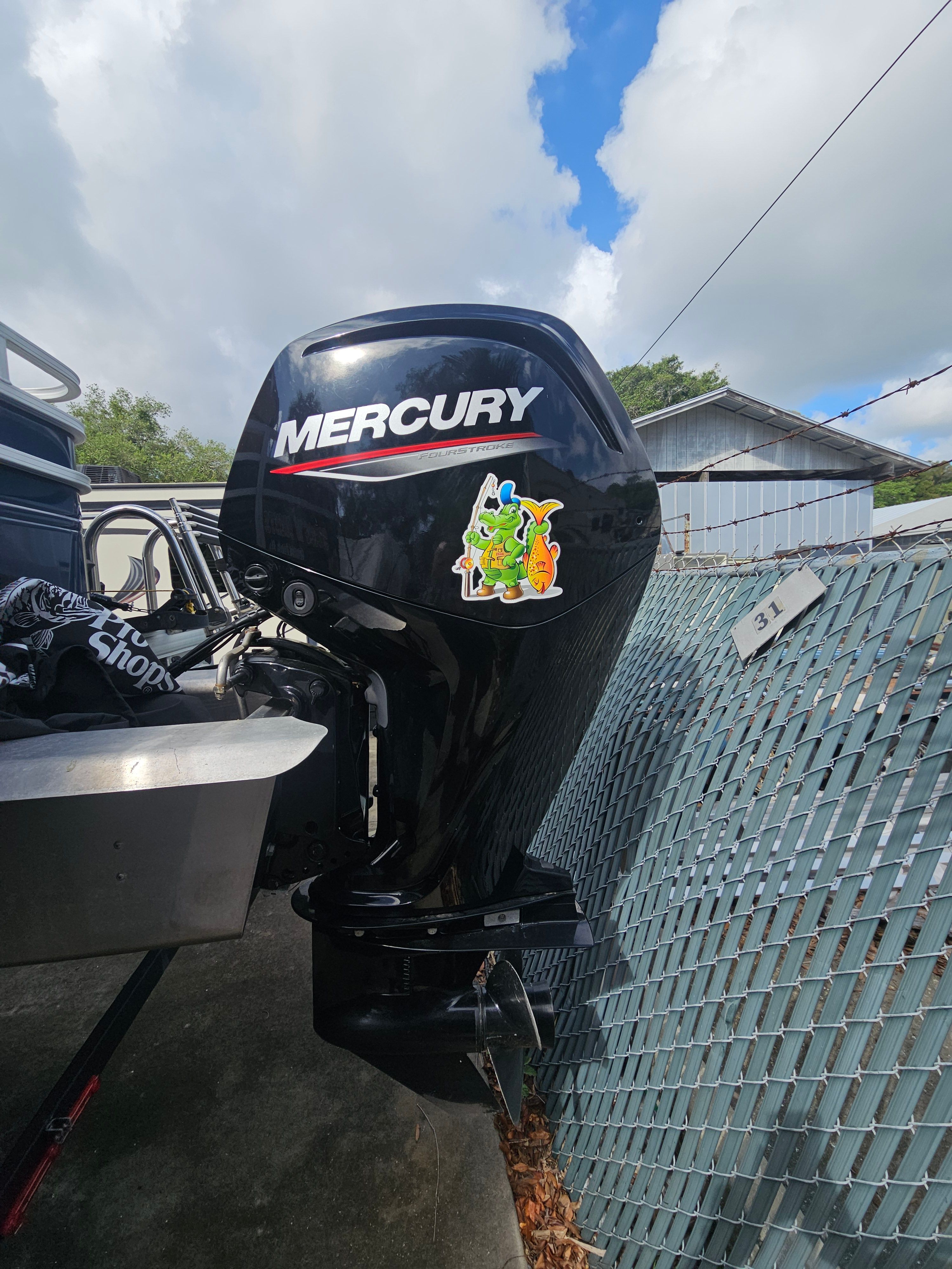 Mercury outboard motor on Sun Tracker Fishin' Barge 22 DLX, 2024 model.