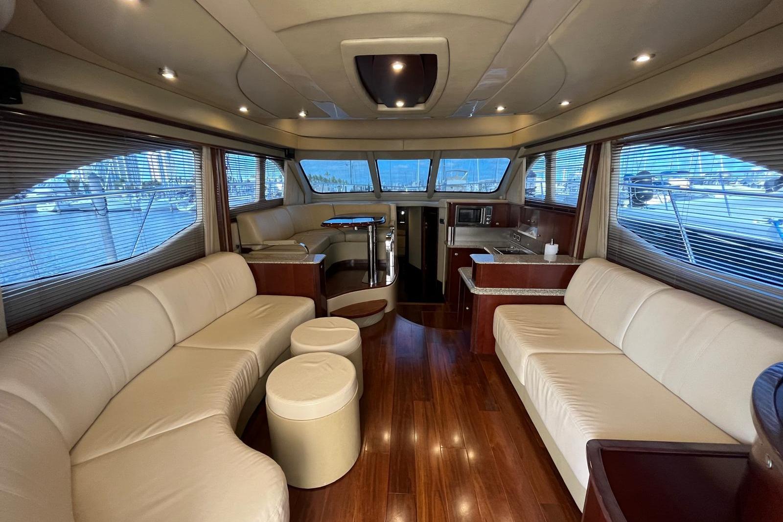 Luxurious interior of 2006 Sea Ray 52 Sedan Bridge yacht with elegant seating and wood finishes.