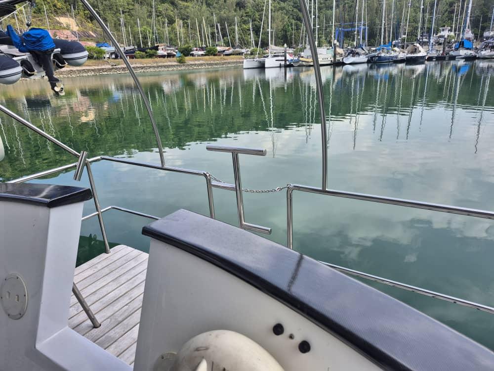 Nordhavn 46 yacht docked in a serene marina, surrounded by sailboats, 1994 model.