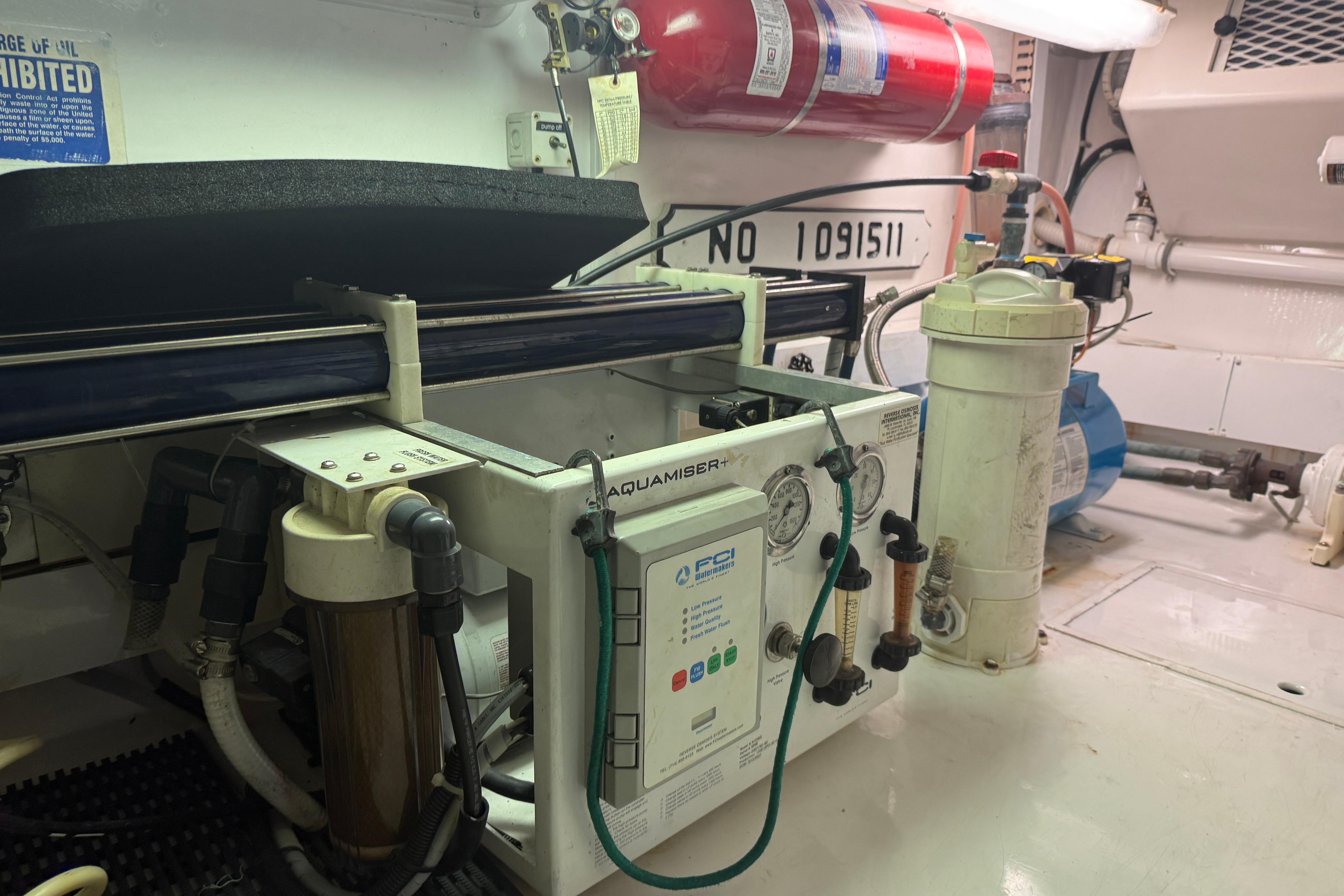 Engine room of a 2000 Viking 55 Convertible yacht with water filtration system.
