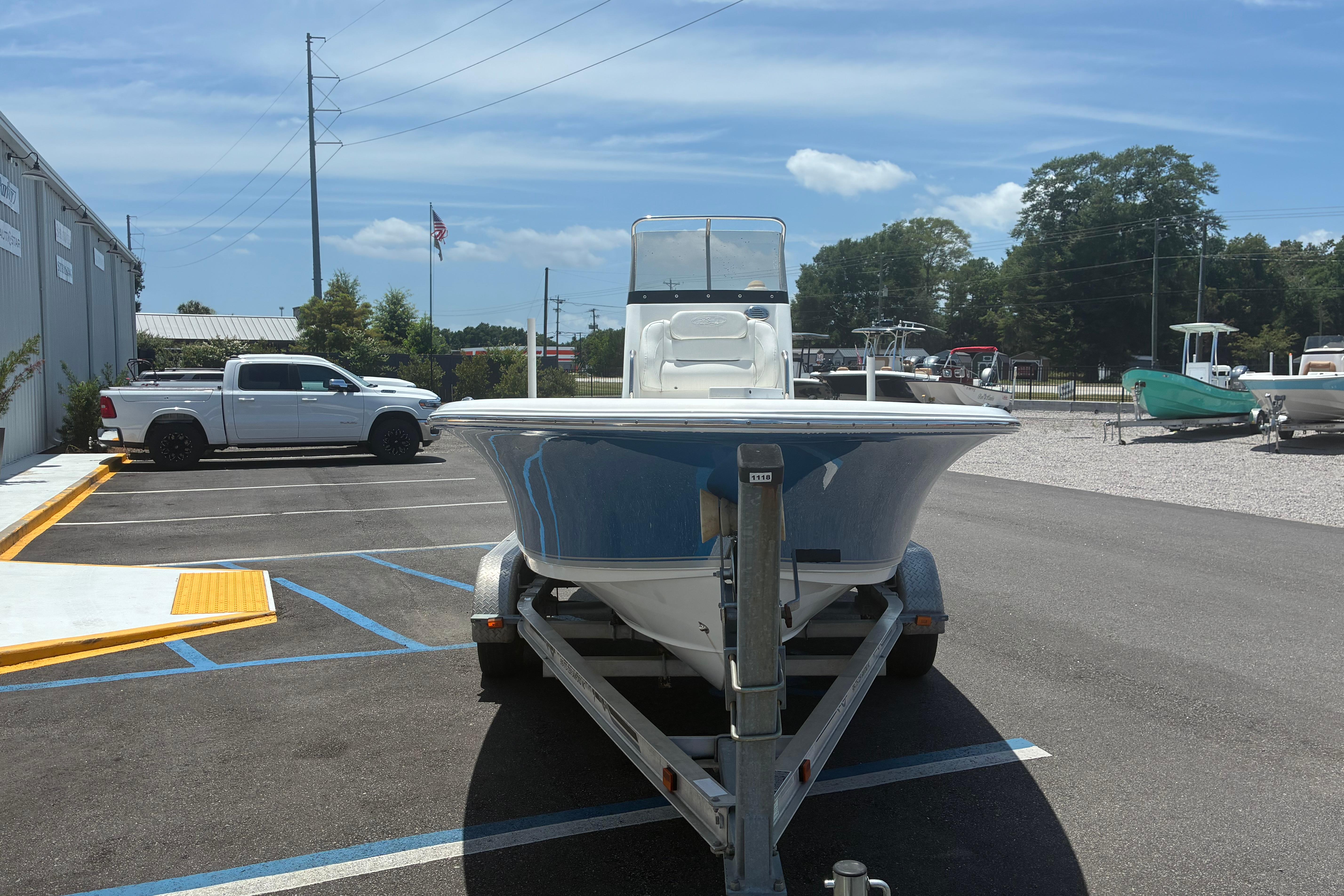 2014 Sea Hunt BX 20 BR boat on trailer in parking lot, sunny day.