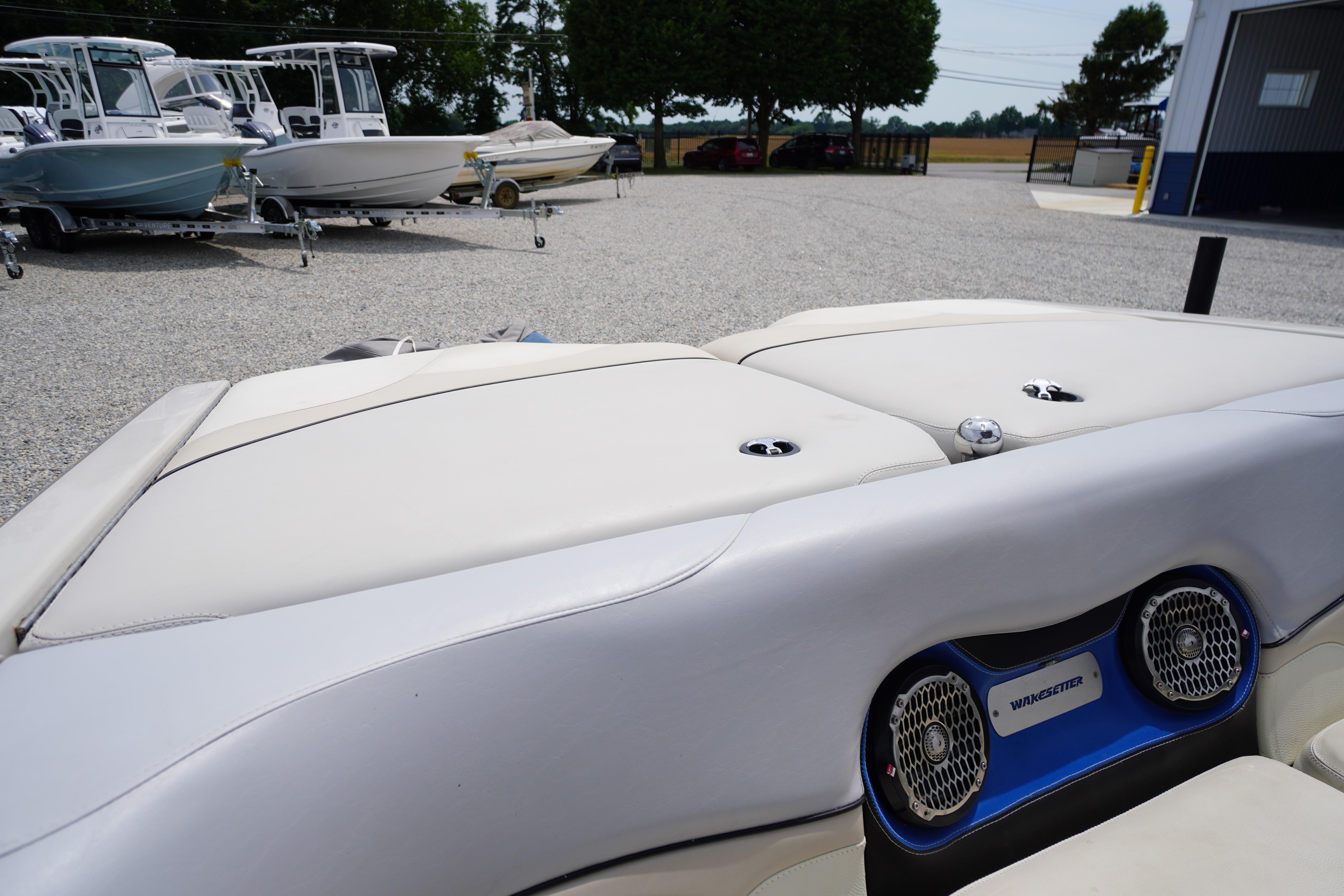 2011 Malibu Wakesetter 21 VLX boat interior with speakers, parked among other boats.