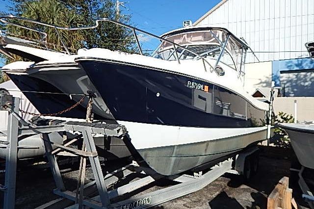 2003 World Cat 270 EC boat on trailer, parked outdoors.