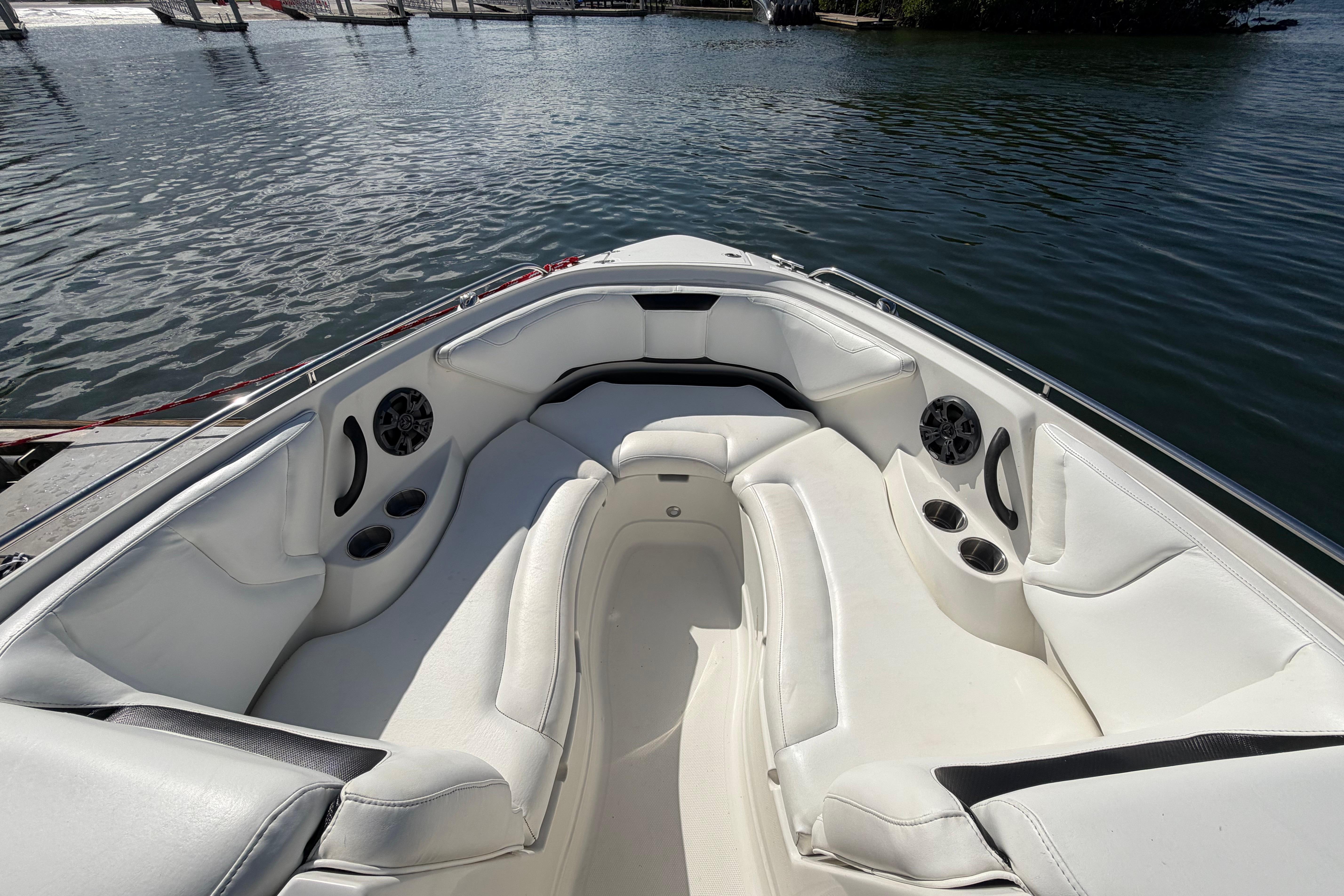 2015 Monterey 264FS boat interior with white seating and cup holders on calm water.