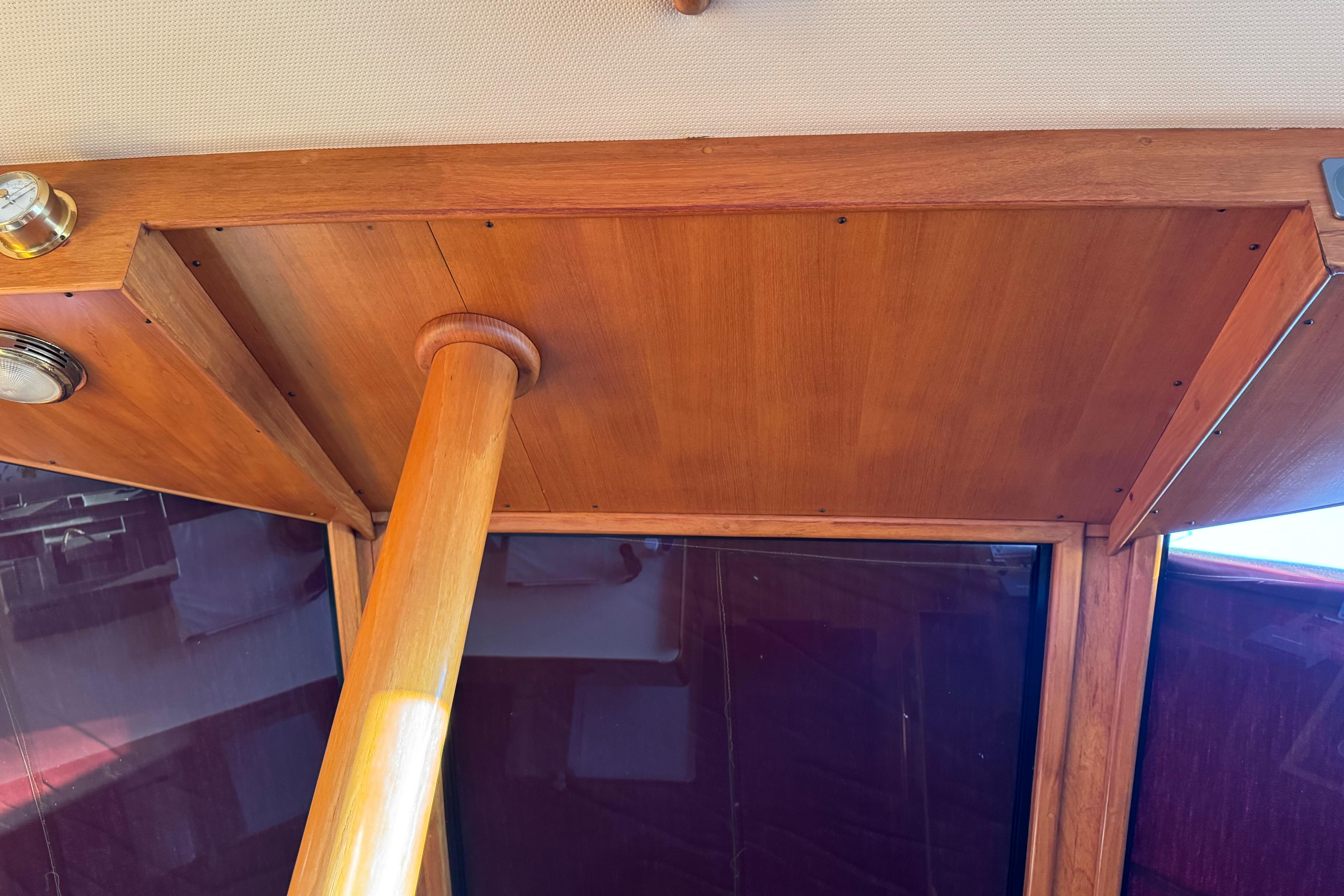 Interior view of a 1987 President 37 boat, showcasing wooden ceiling and support beam.