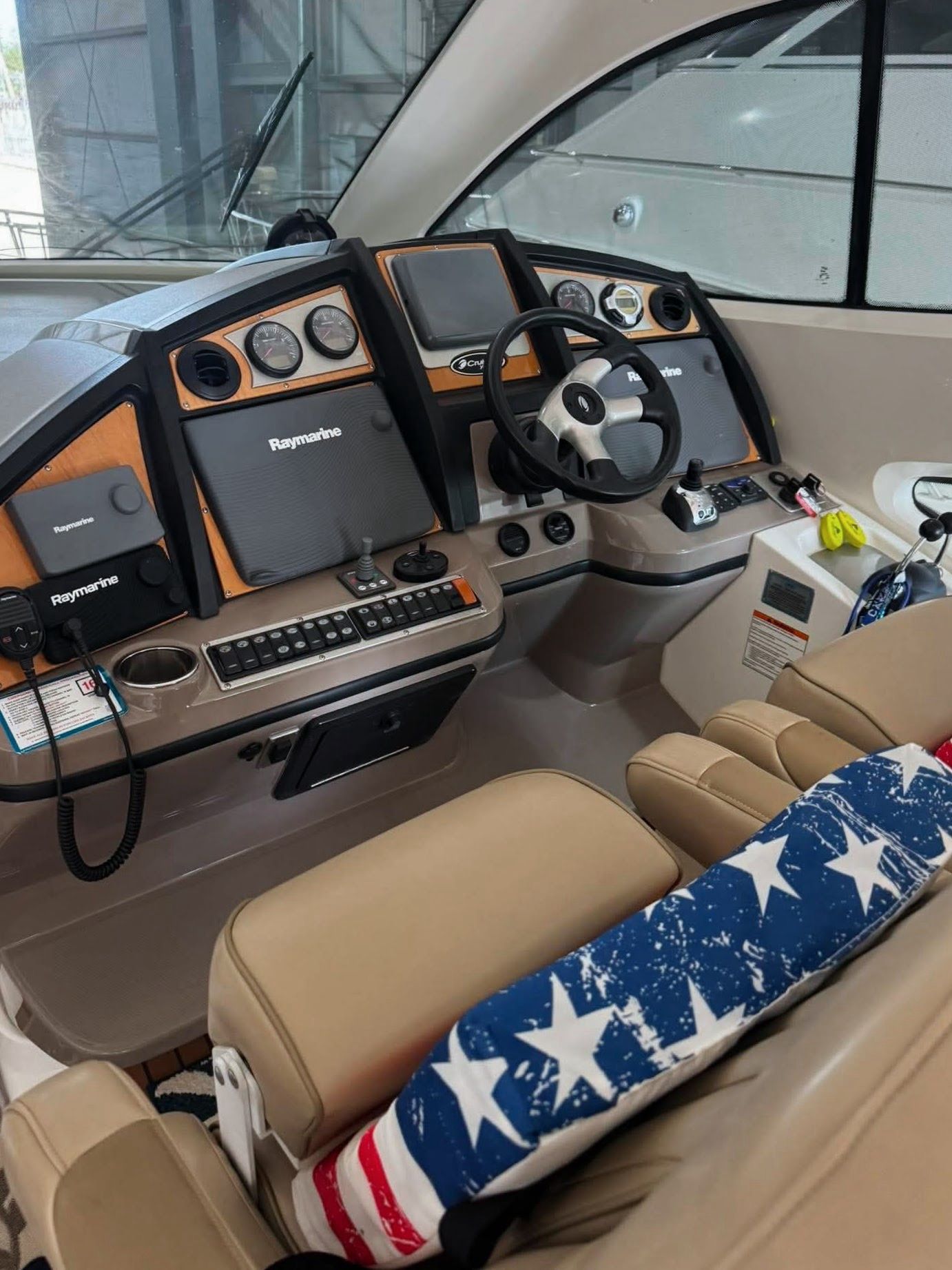 The cockpit of a 2009 Cruisers Yachts 520 Sports Coupe with modern instruments and comfortable seating.