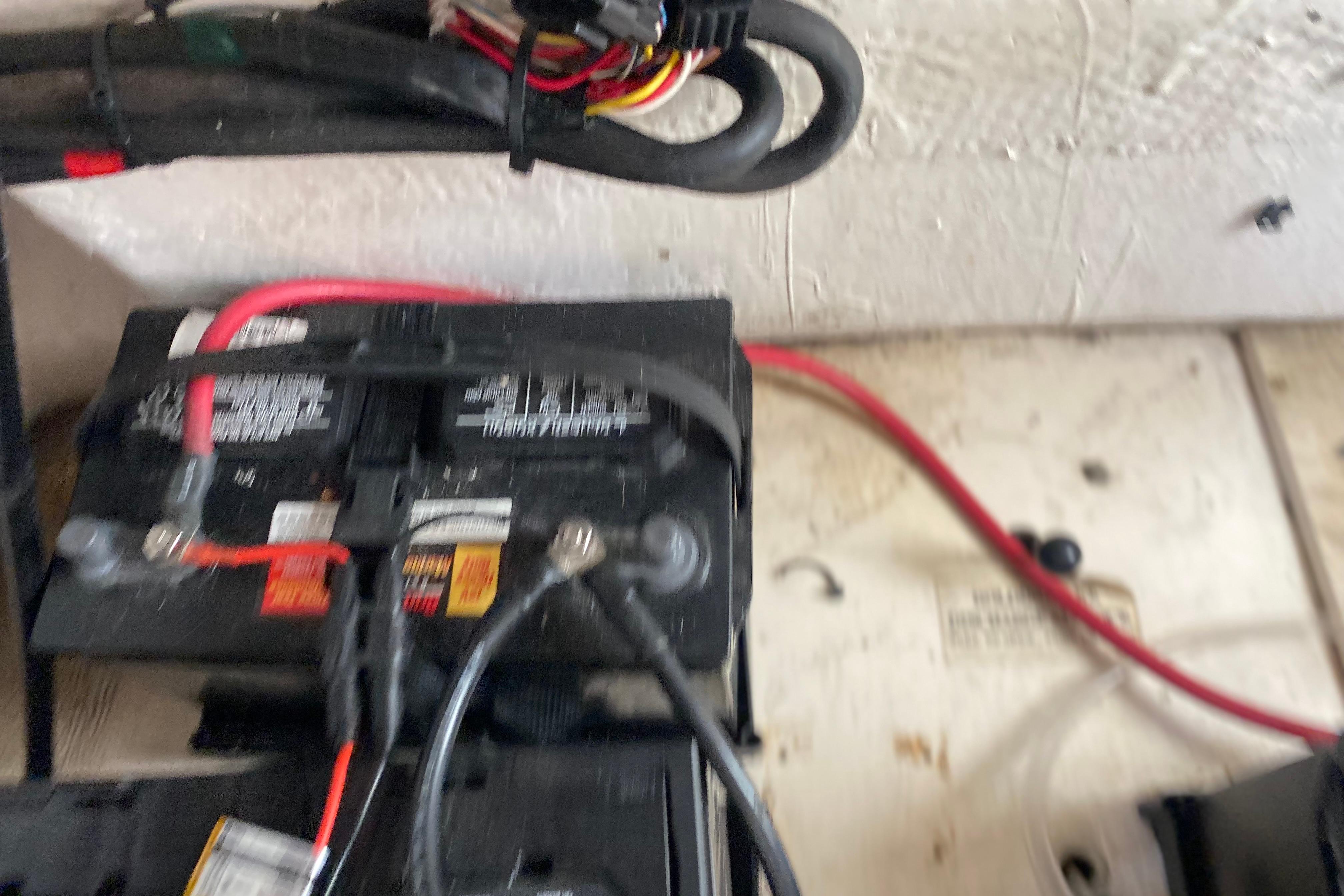 Battery setup in a 2004 Grady-White Canyon 283 boat, featuring wiring and connections.