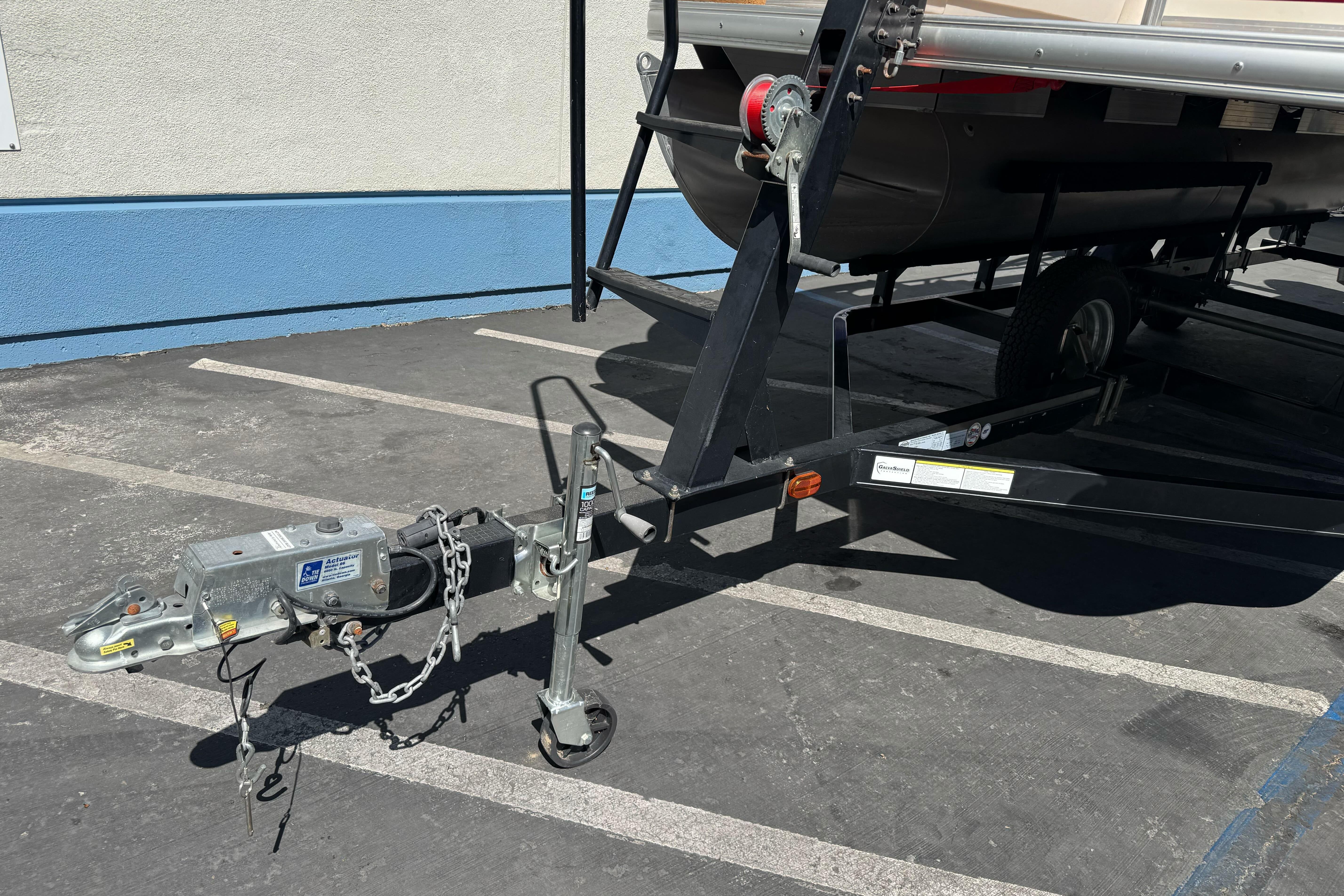 2011 Sun Tracker Party Barge 21 trailer hitch in parking lot.