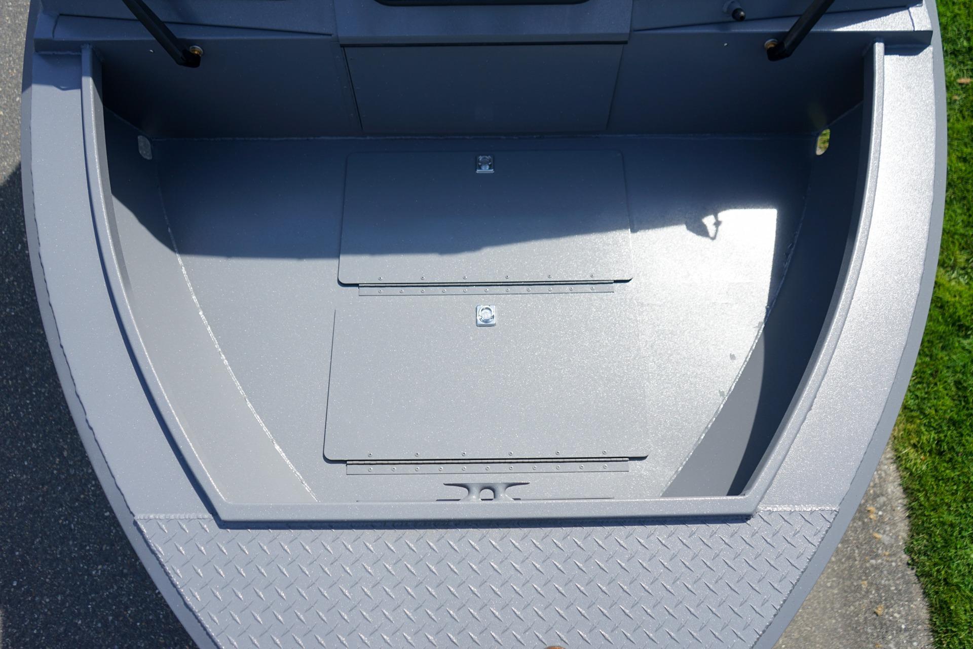 2026 Alumaweld Talon 18 boat interior, featuring a spacious, gray deck with storage compartments.