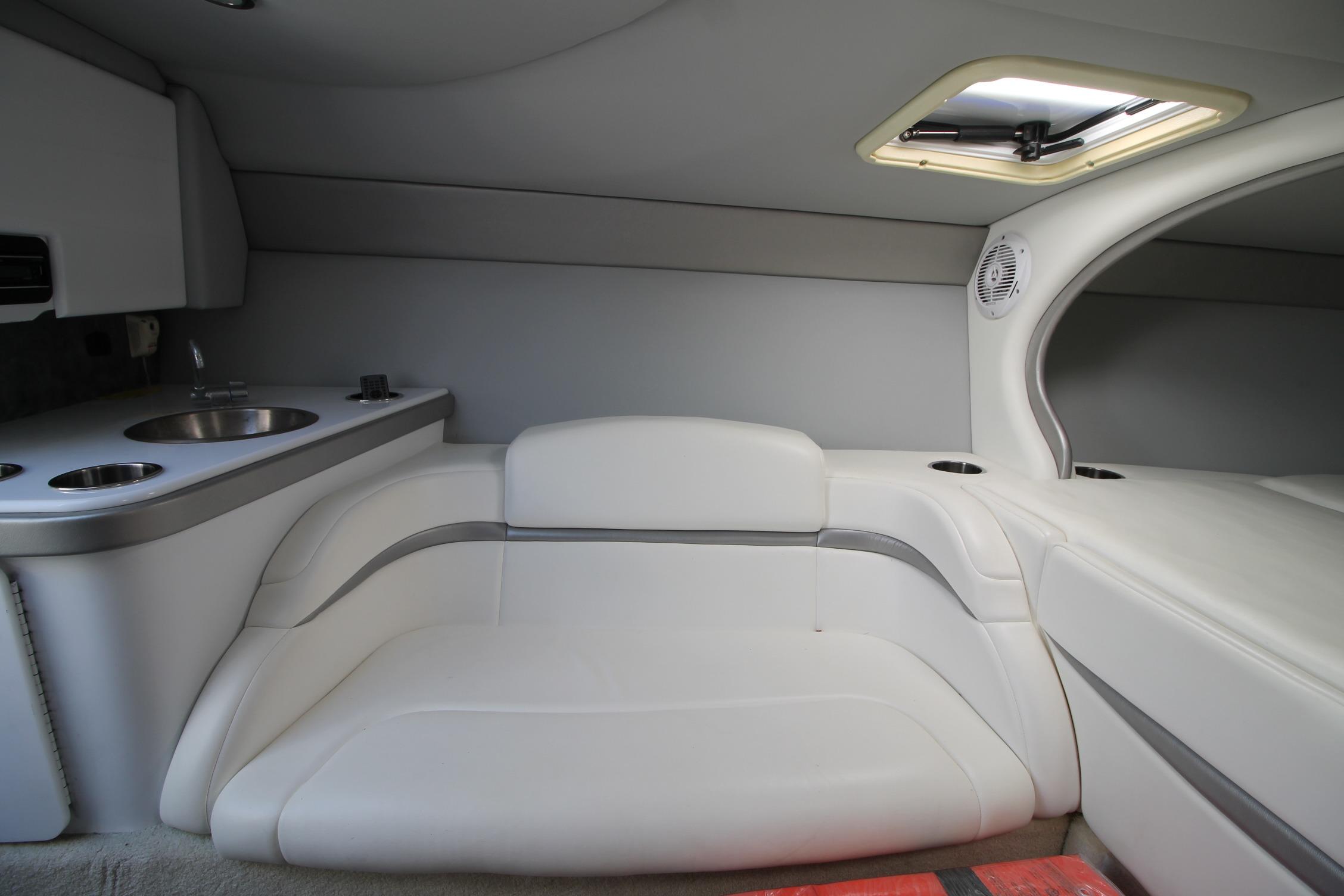 Interior of 2006 Formula 292 FASTech boat with white seating and kitchenette.