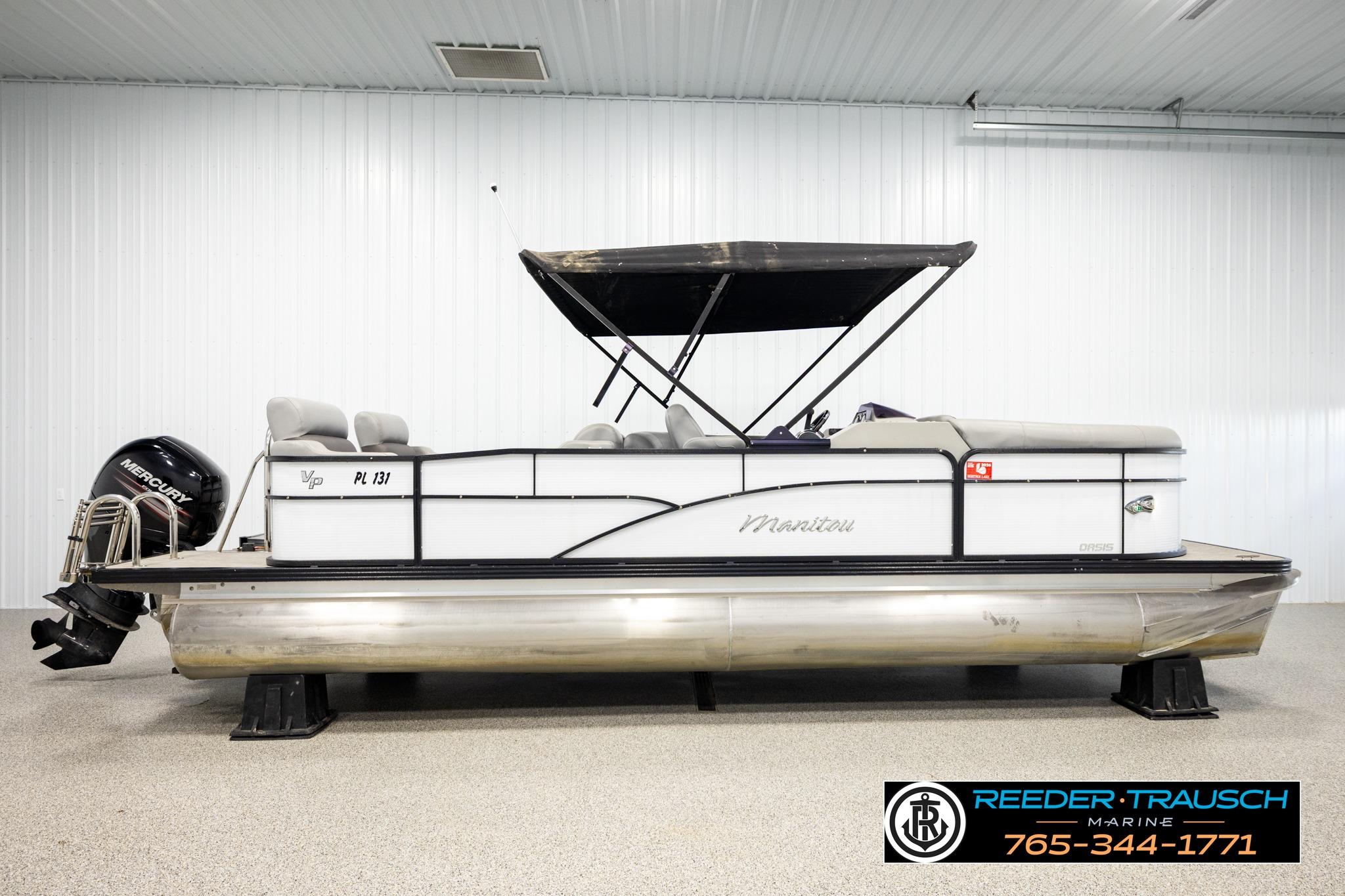 2019 Manitou Oasis SR VP pontoon boat with Mercury engine in showroom.